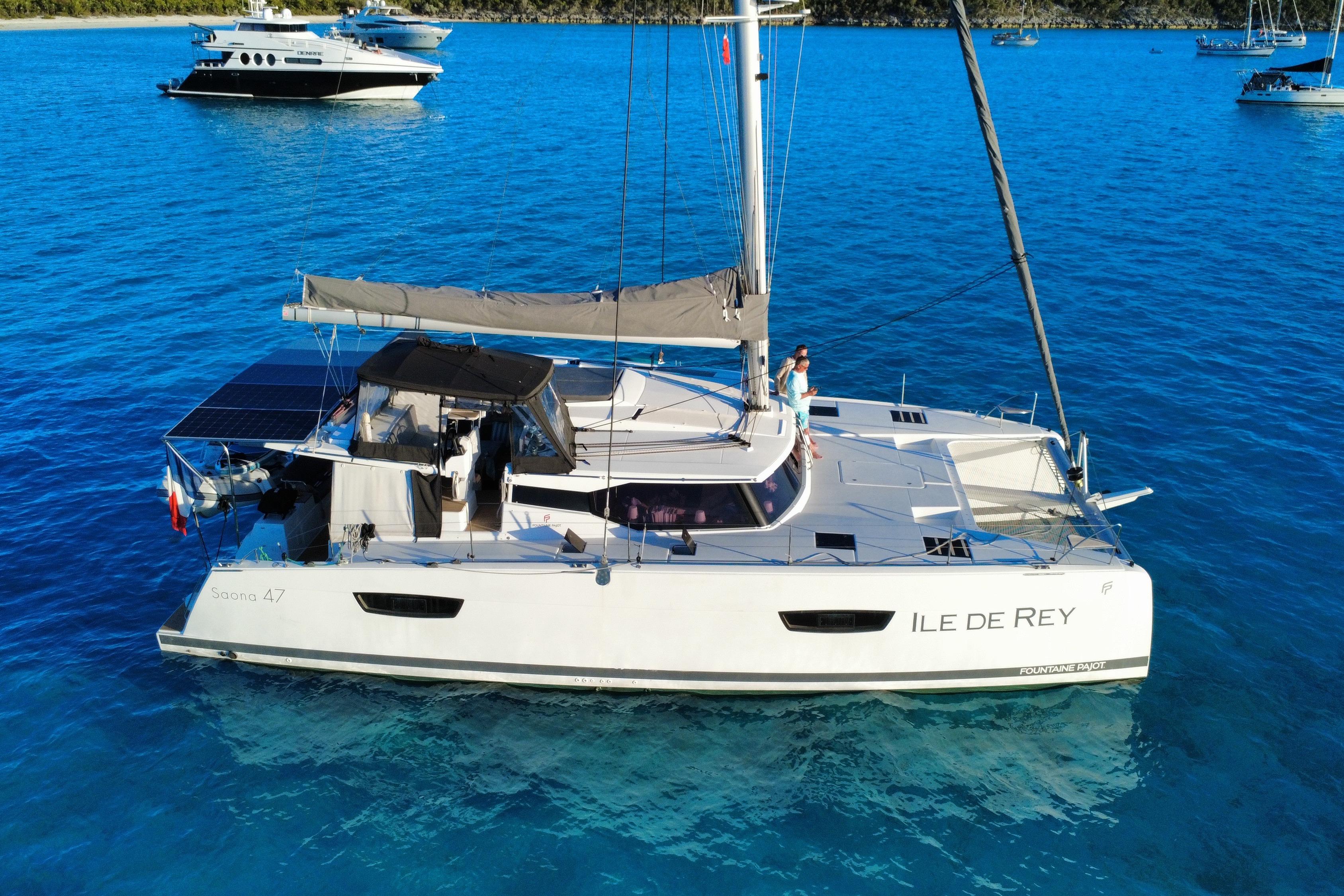 2020 Fountaine Pajot Saona 47 catamaran sailing on clear blue waters.