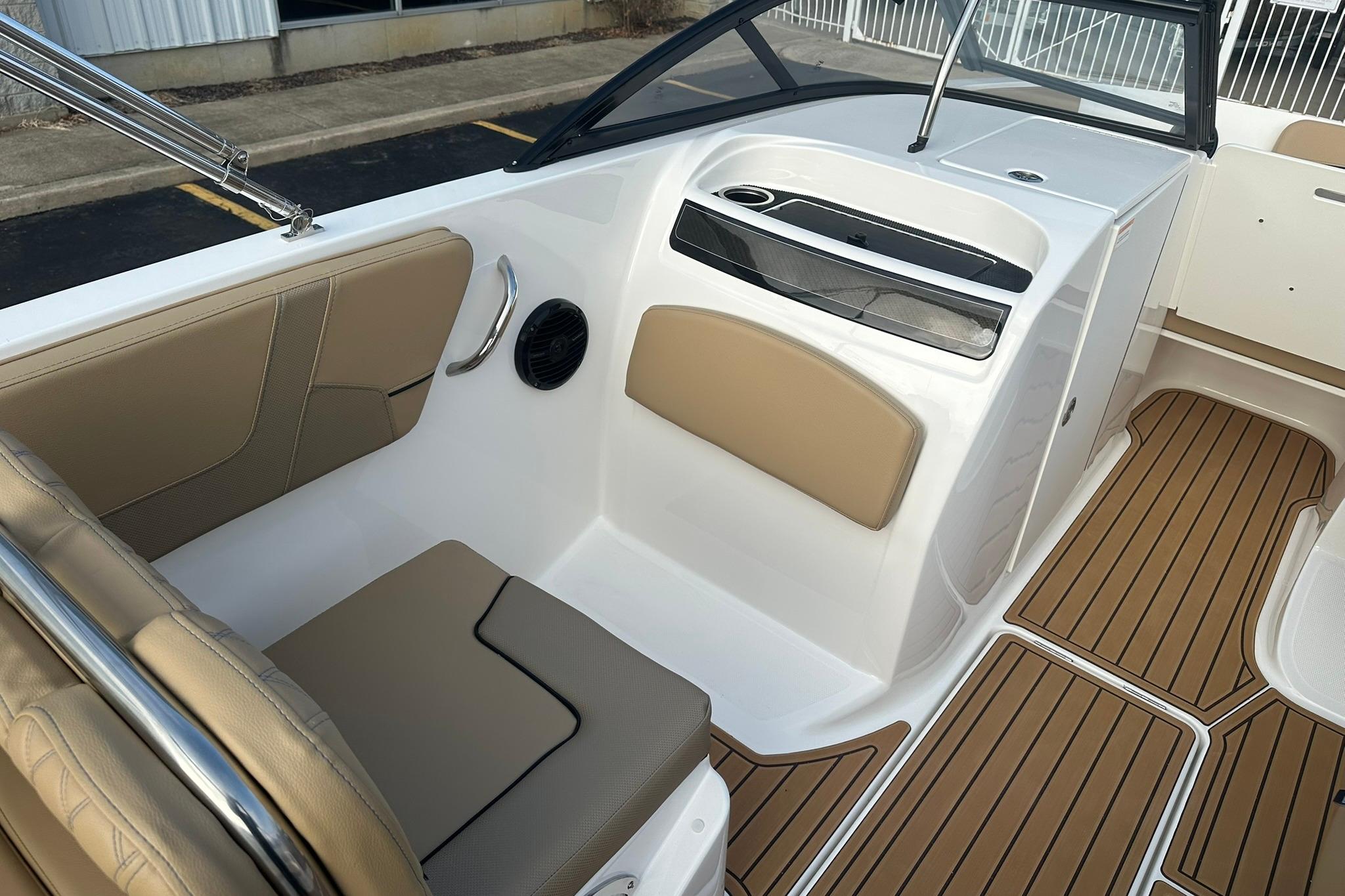 2026 Bayliner VR6 Bowrider OB interior with tan seating and wood-style flooring.