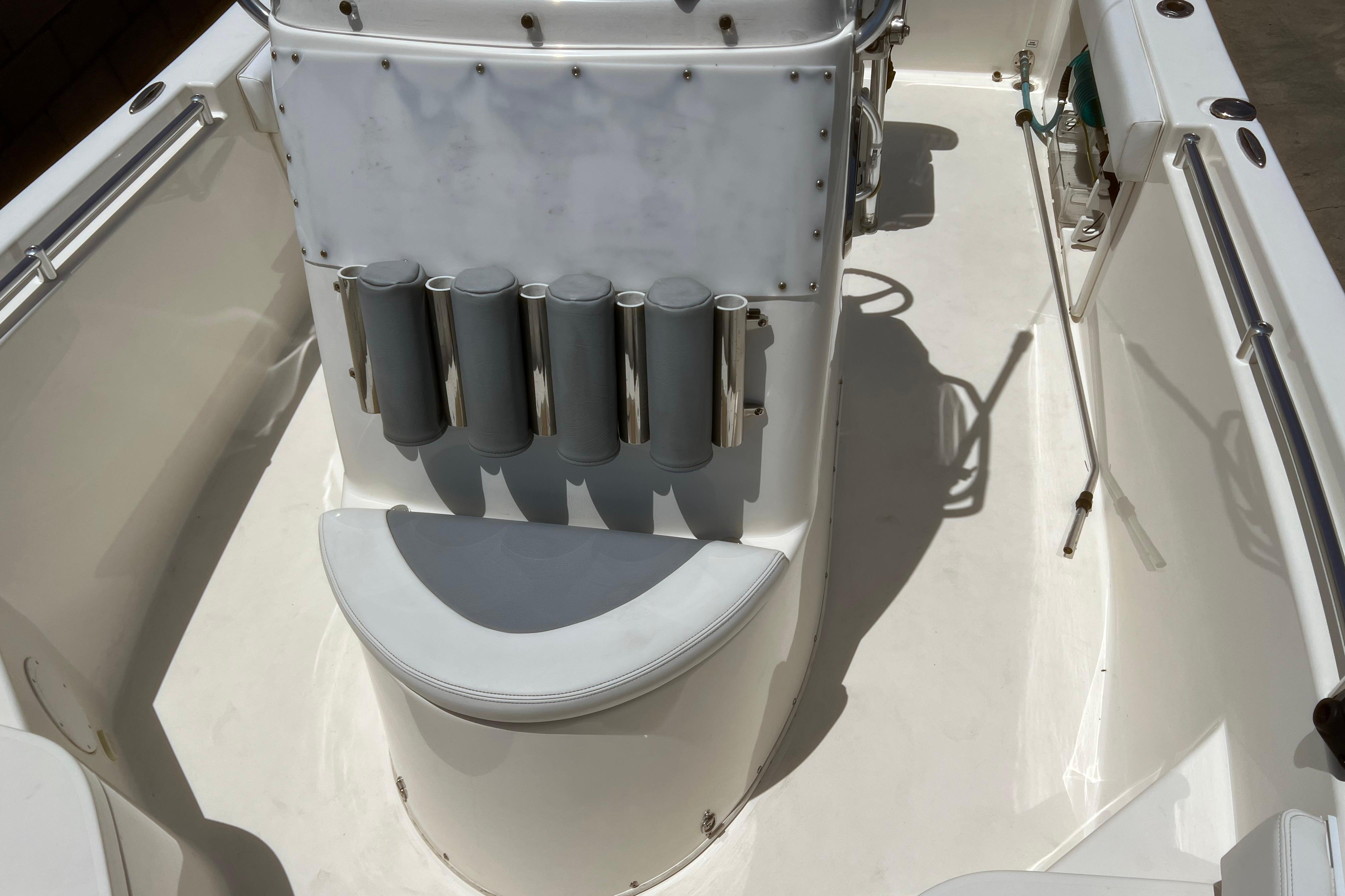 2018 Cobia 201 Center Console boat interior with rod holders and seating.