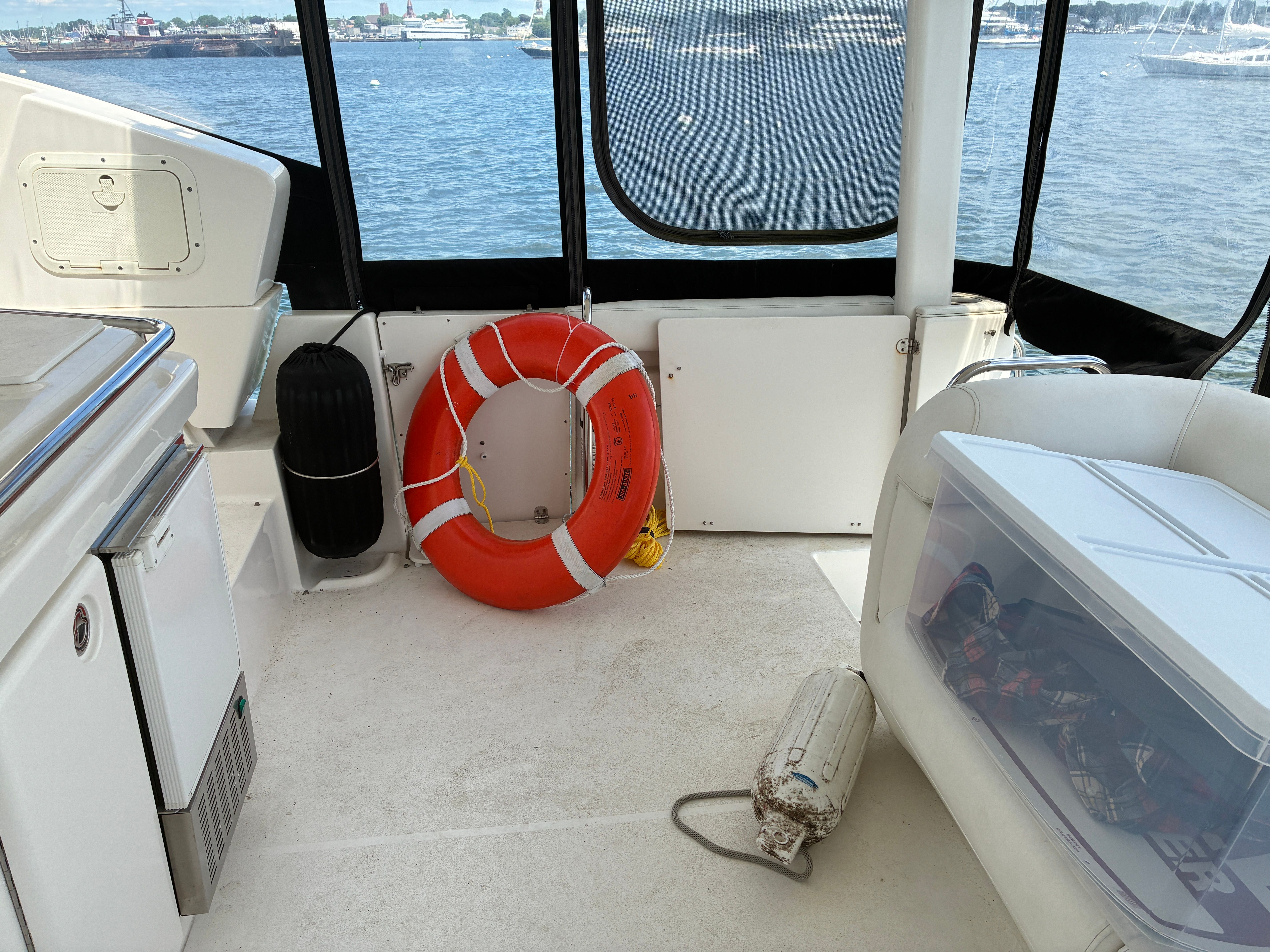 The image shows the deck of a 2001 Silverton 392 Motor Yacht. A life ring is visible.