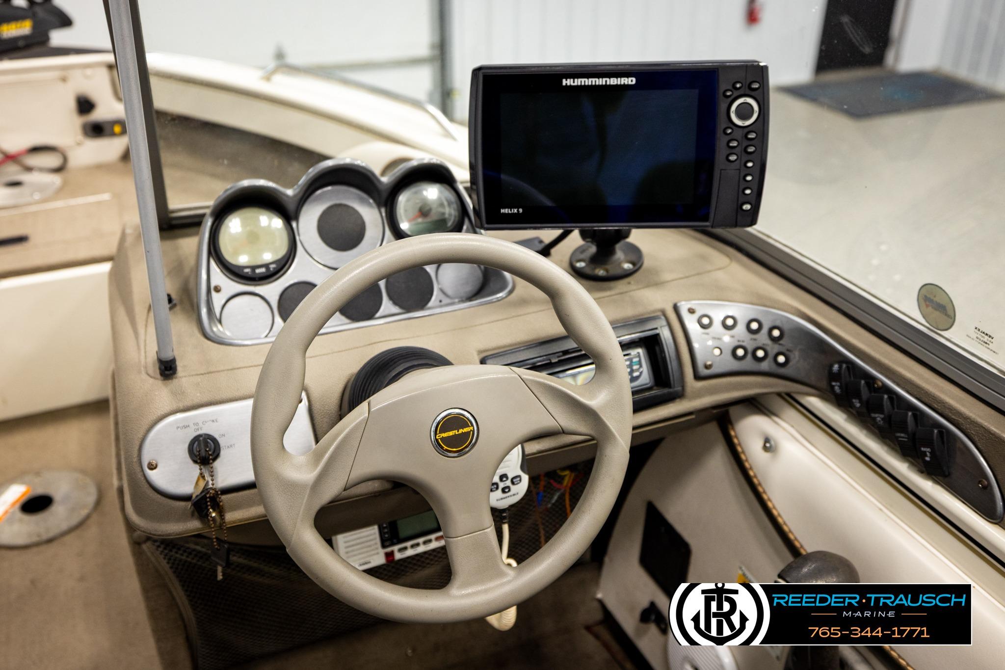 2004 Crestliner 2050 Sportfish boat dashboard with steering wheel and Humminbird electronics.