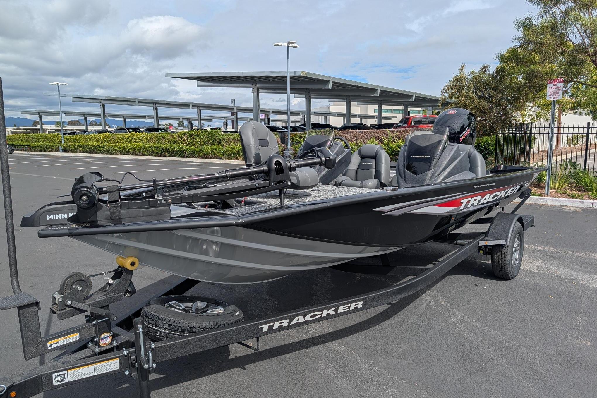 2026 Tracker Pro Team 195 fishing boat on trailer in parking lot.