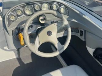 2005 Bayliner 205 Bowrider dashboard with steering wheel and gauges.