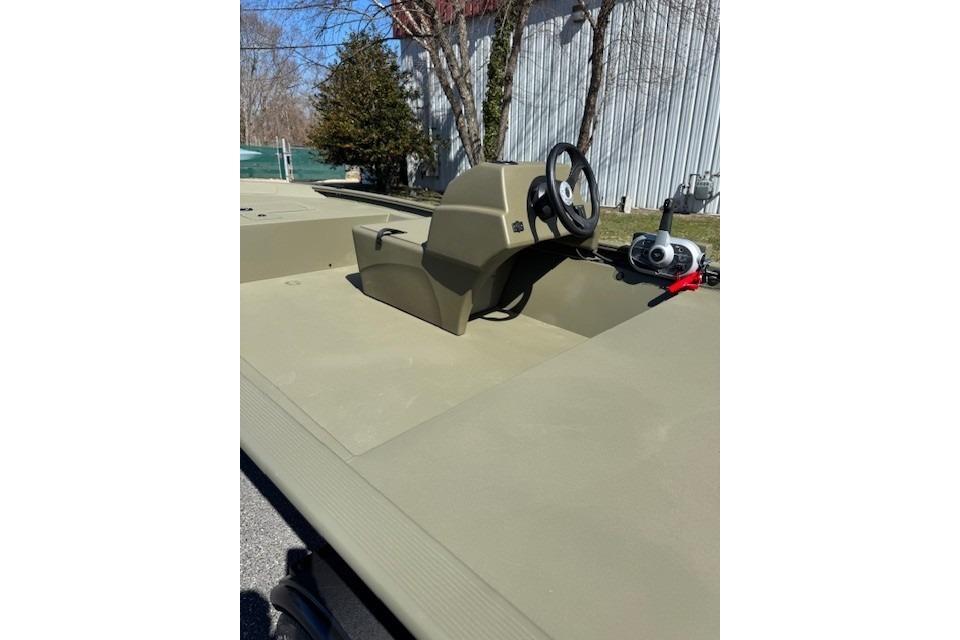 2026 Tracker Grizzly 1648 SC boat with steering console, outdoors.