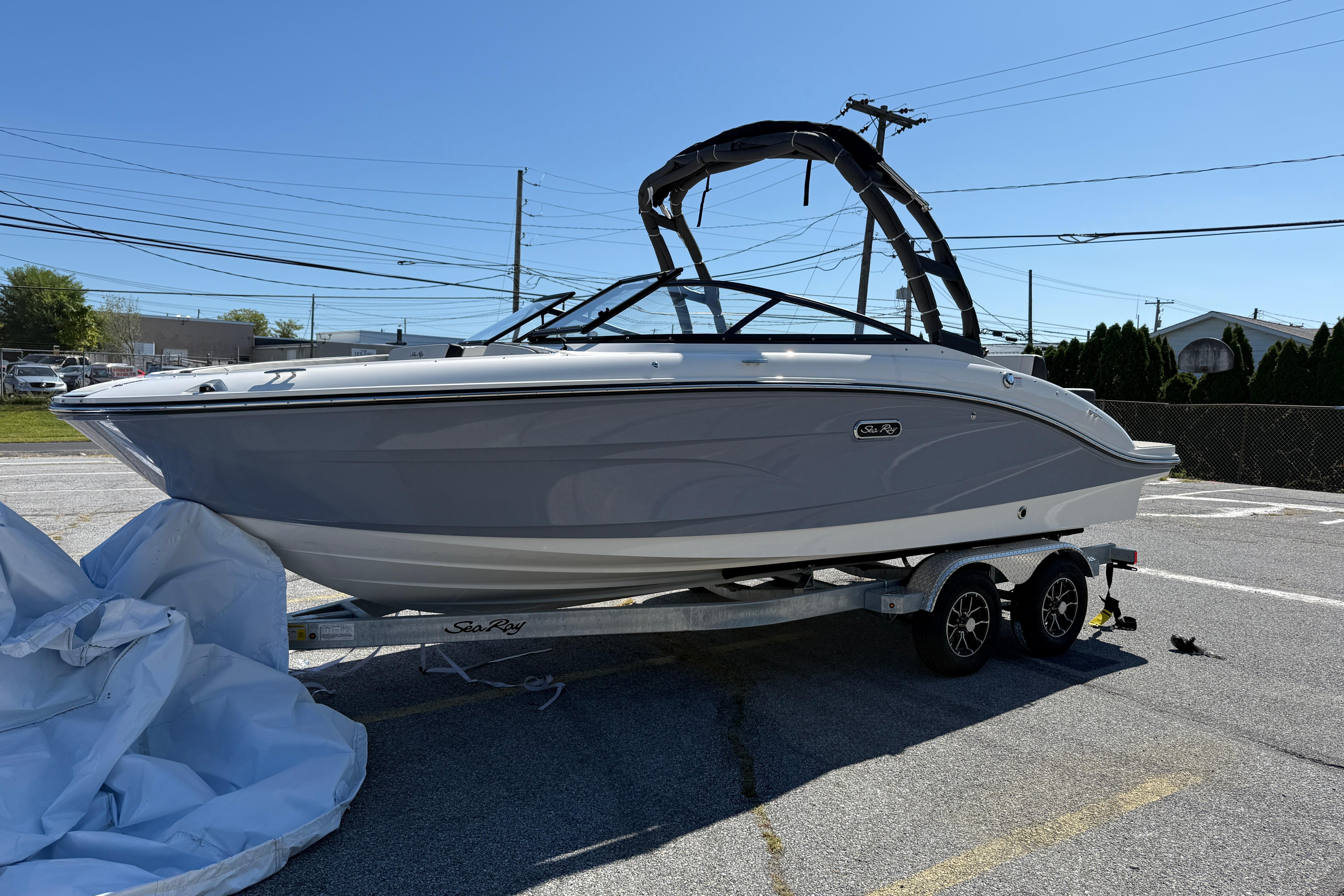 2026 Sea Ray SPX 210 boat on trailer in sunny outdoor setting.