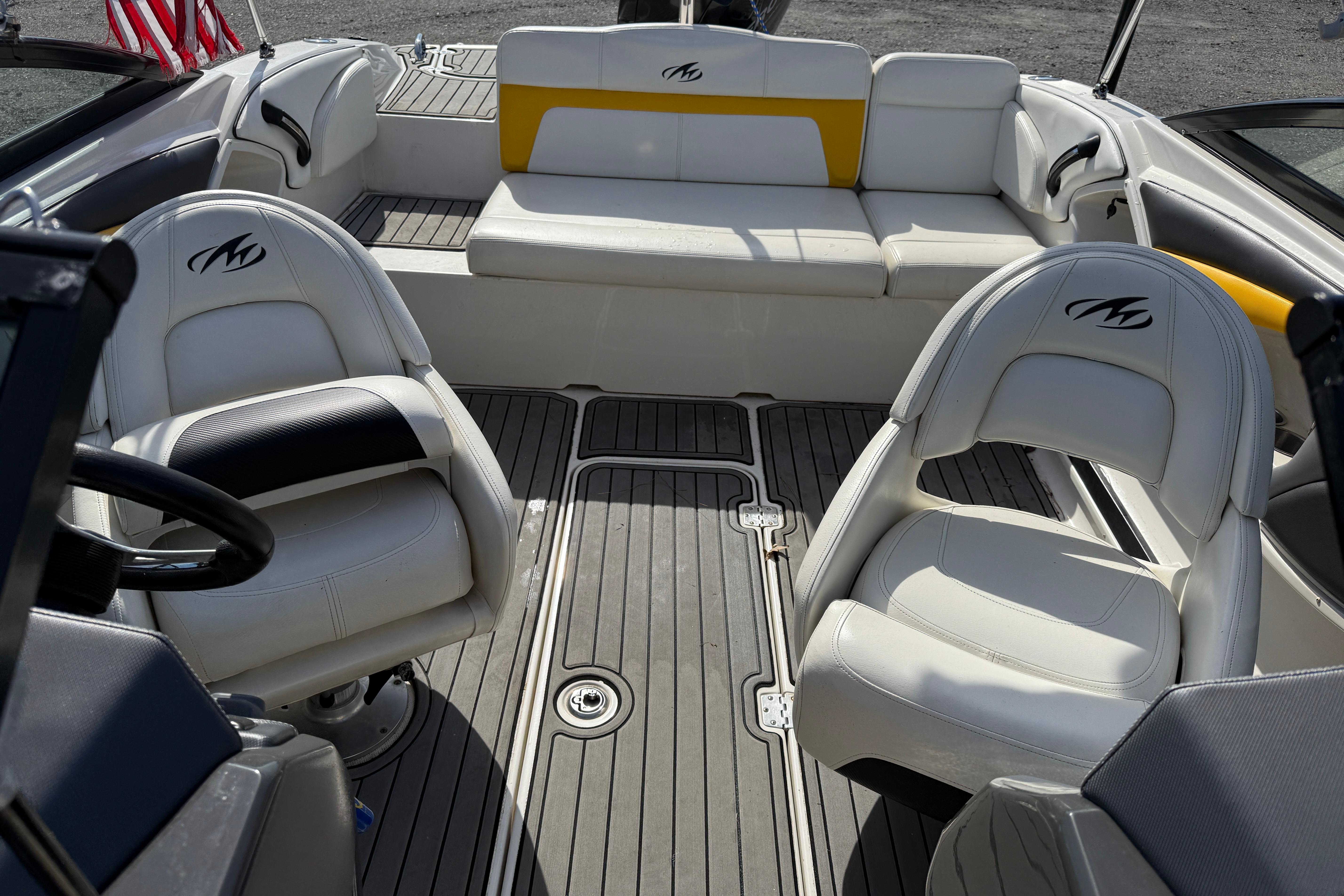 Interior of a 2014 Monterey 197 Blackfin boat with white seating and gray flooring.