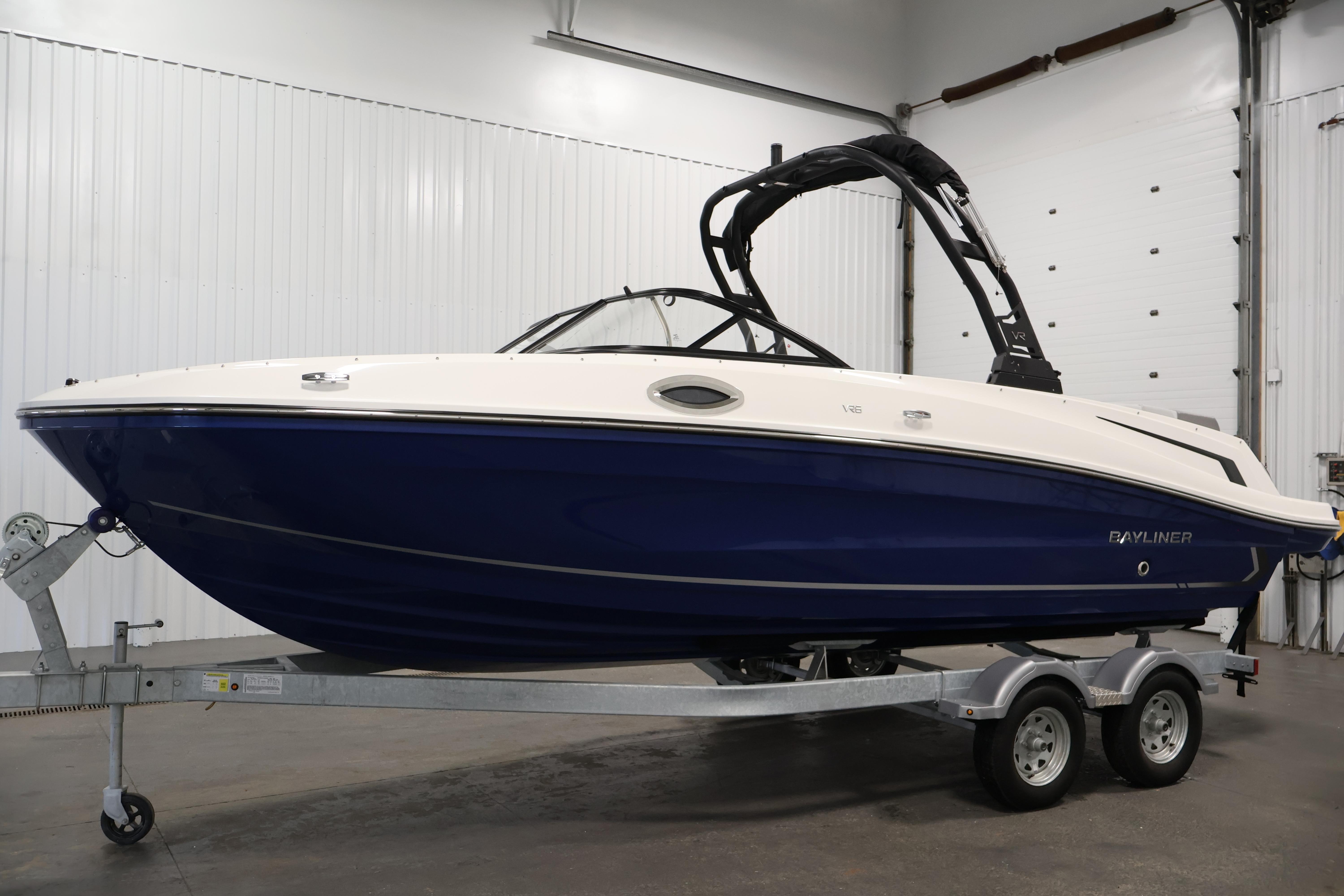 2026 Bayliner VR6 Bowrider I/O boat on trailer in indoor setting.