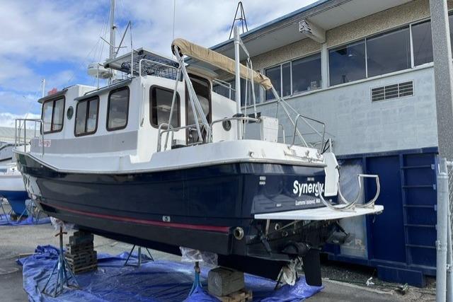 2008 Ranger 25 on dry dock near a building.