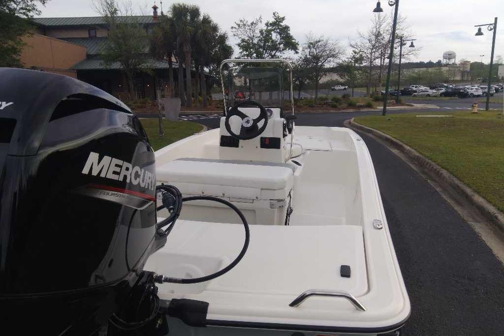 2026 Mako Pro Skiff 15 CC boat with Mercury engine, parked outdoors.