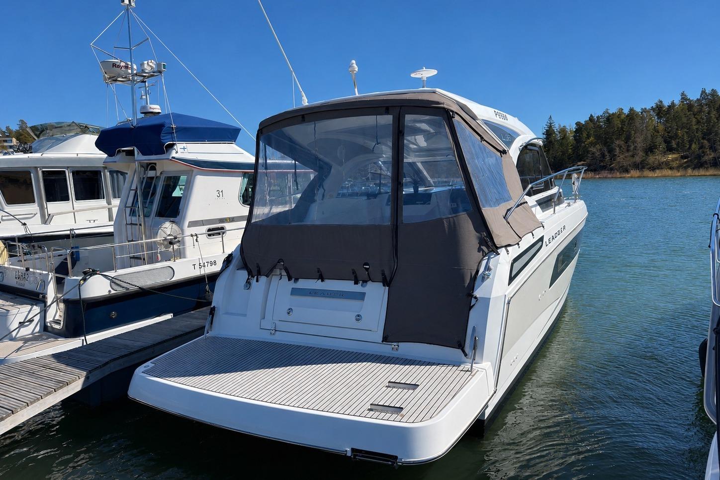 2018 Jeanneau Leader 33 yacht docked at marina, featuring sleek design and covered cockpit.