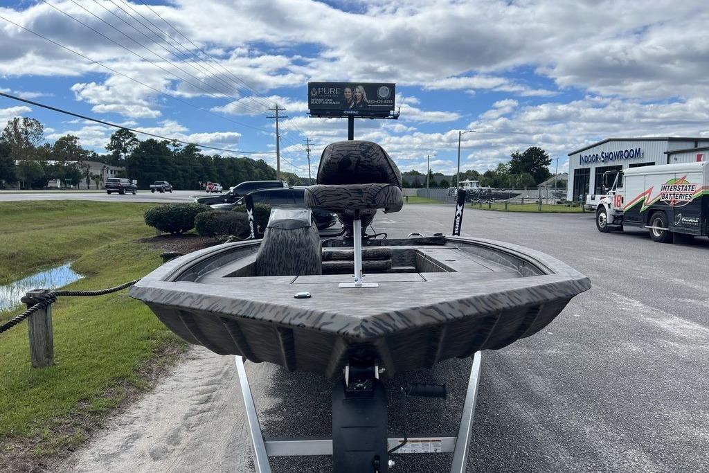 2026 Xpress XP200 boat on trailer, outdoor showroom, cloudy sky background.