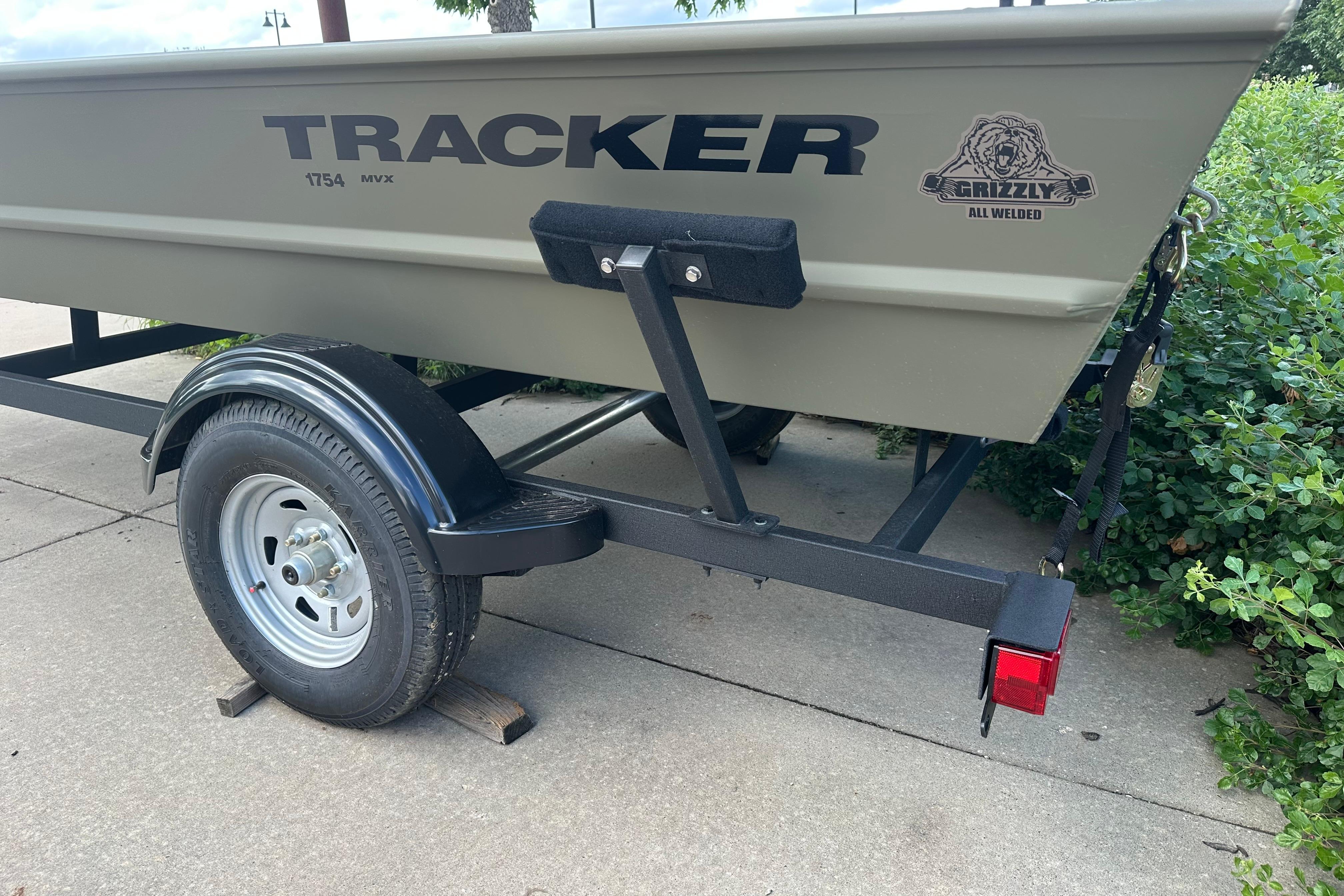 2026 Tracker Grizzly 1754 Utility boat on trailer, side view with logo.