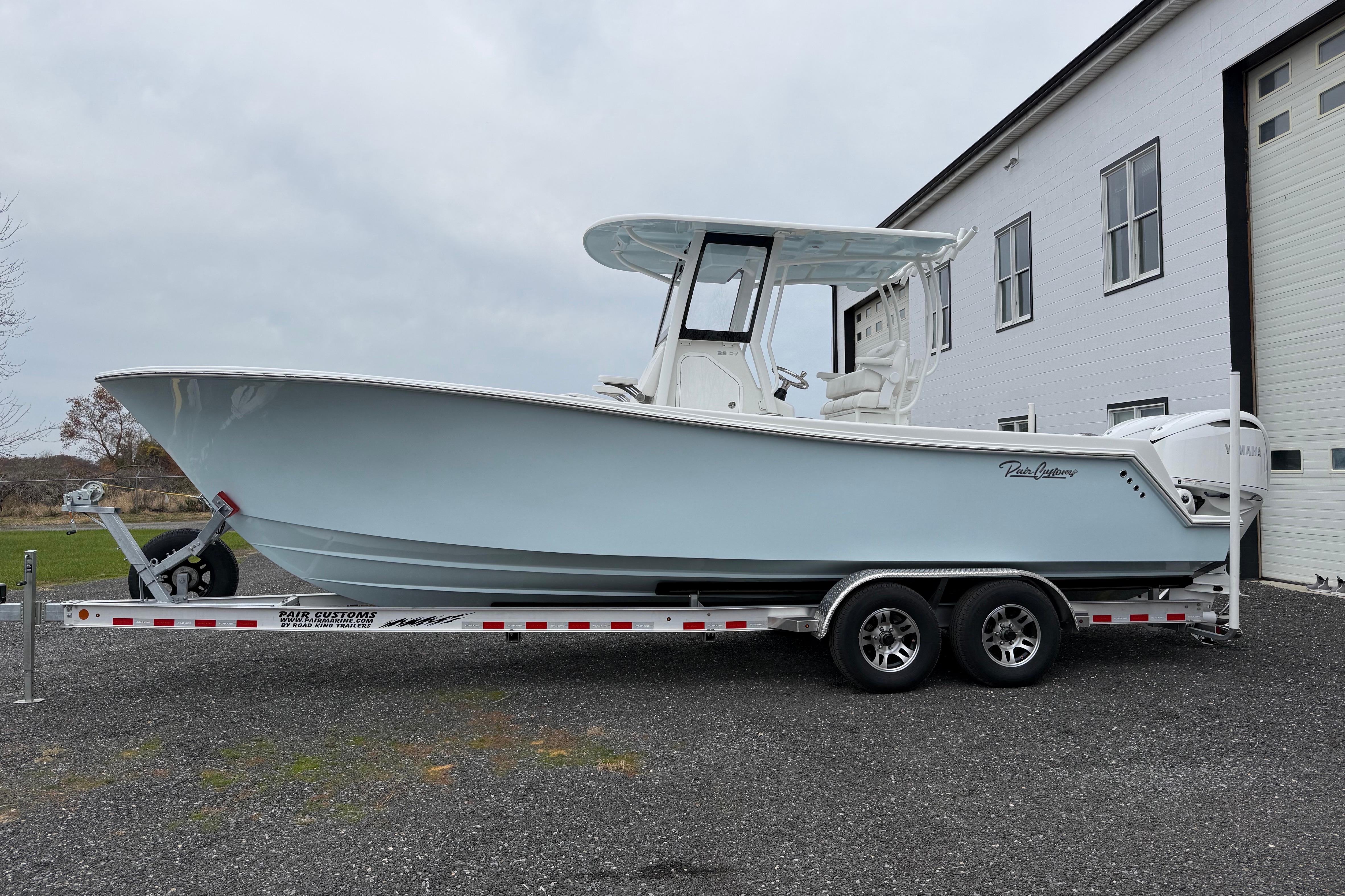 2026 Pair Customs 28 Center Console boat on trailer, parked near a building.