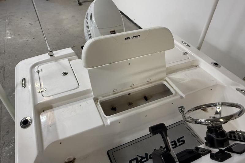 2026 Sea Pro 172 Bay boat interior with steering wheel and storage compartments.