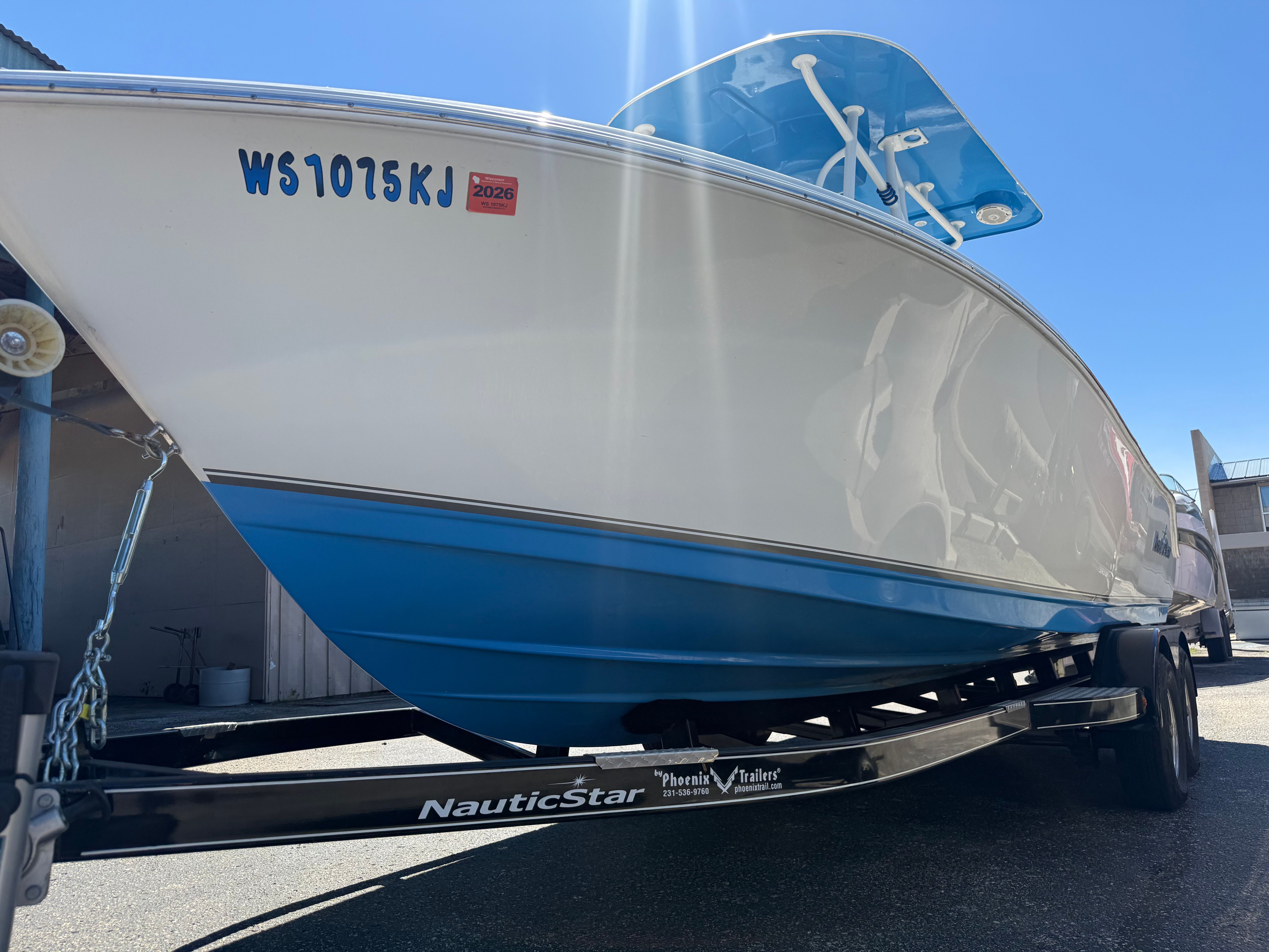 A NauticStar 22 XS boat on a trailer, ready for transport.