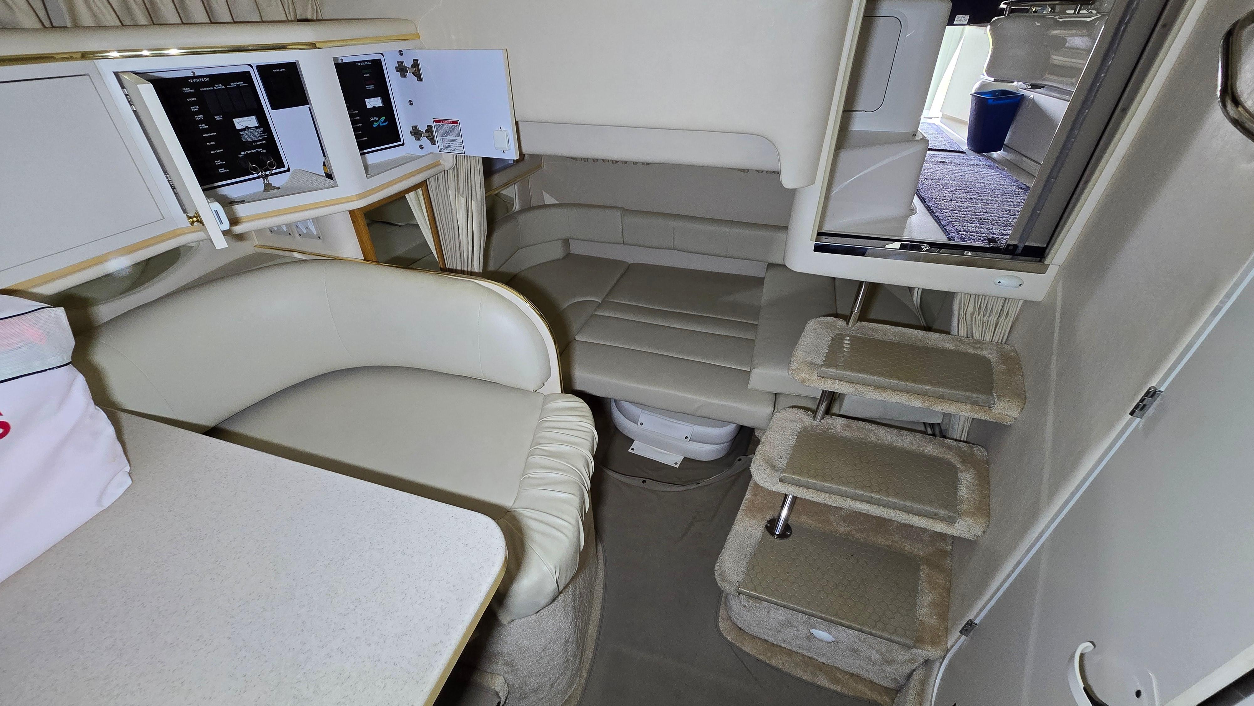 Interior of 2000 Sea Ray 310 Sundancer with seating and stairs.