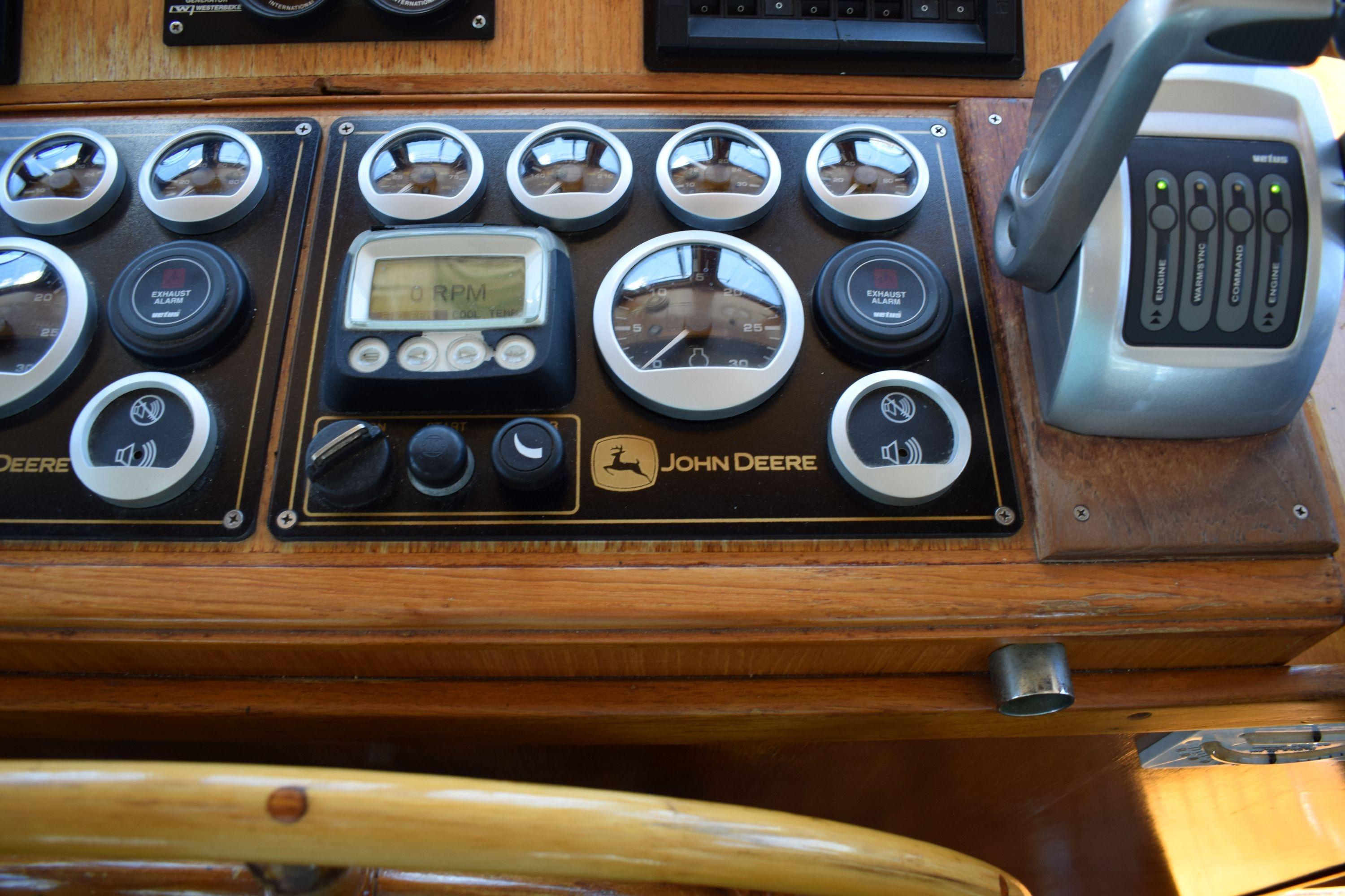 Control panel of a 1980 Cheoy Lee 52 Motorsailer with John Deere gauges and controls.