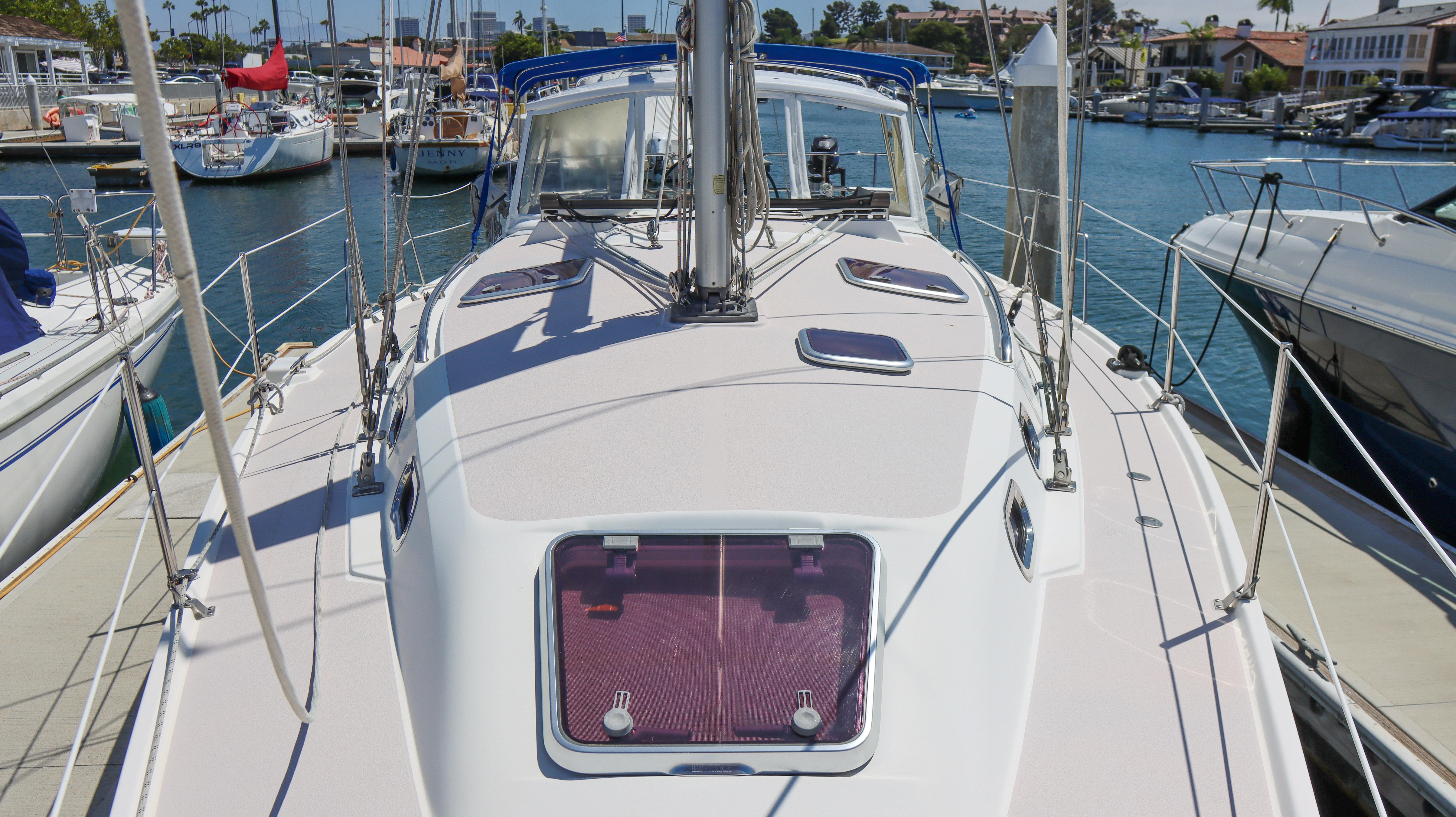 2010 Catalina 375 sailboat docked in a marina, showcasing deck and hatch details.