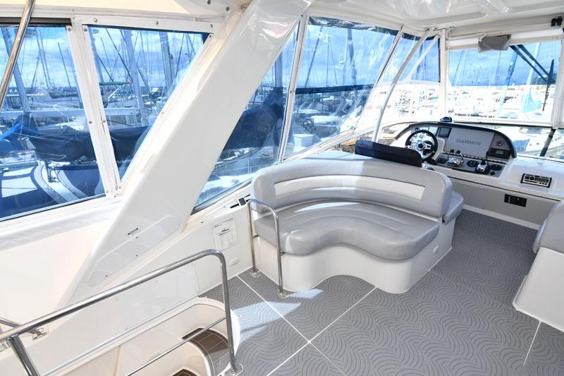 Luxurious interior of 2008 Carver 43 Super Sport yacht with modern seating and helm.