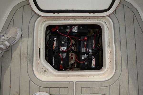 2021 Sea Pro 228 Bay boat battery compartment with multiple batteries and wiring.