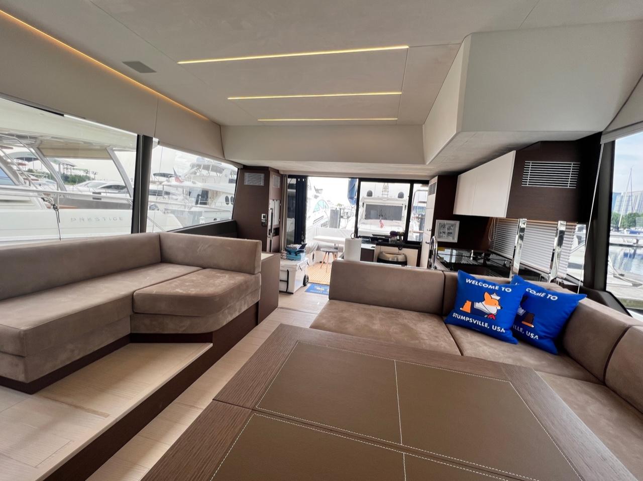 Luxurious interior of 2021 Prestige 590 Sport Fly yacht with plush seating and modern design.