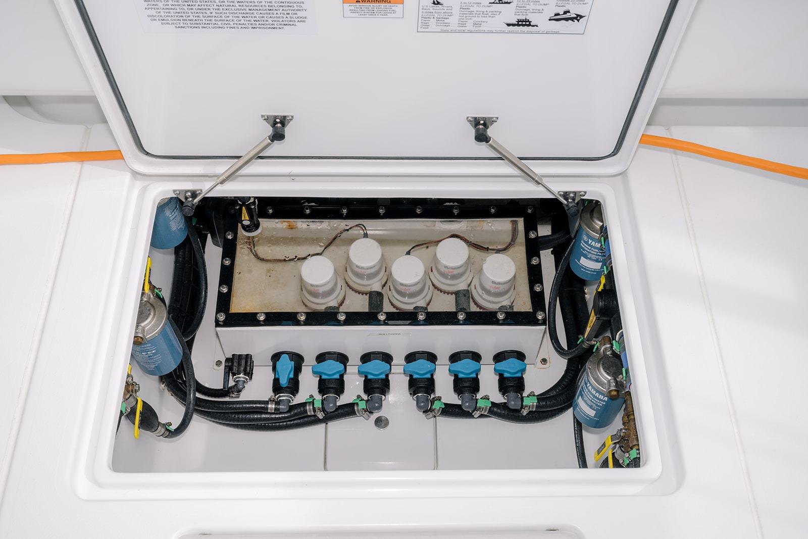 2024 Contender 44 ST boat engine compartment with filters and wiring.