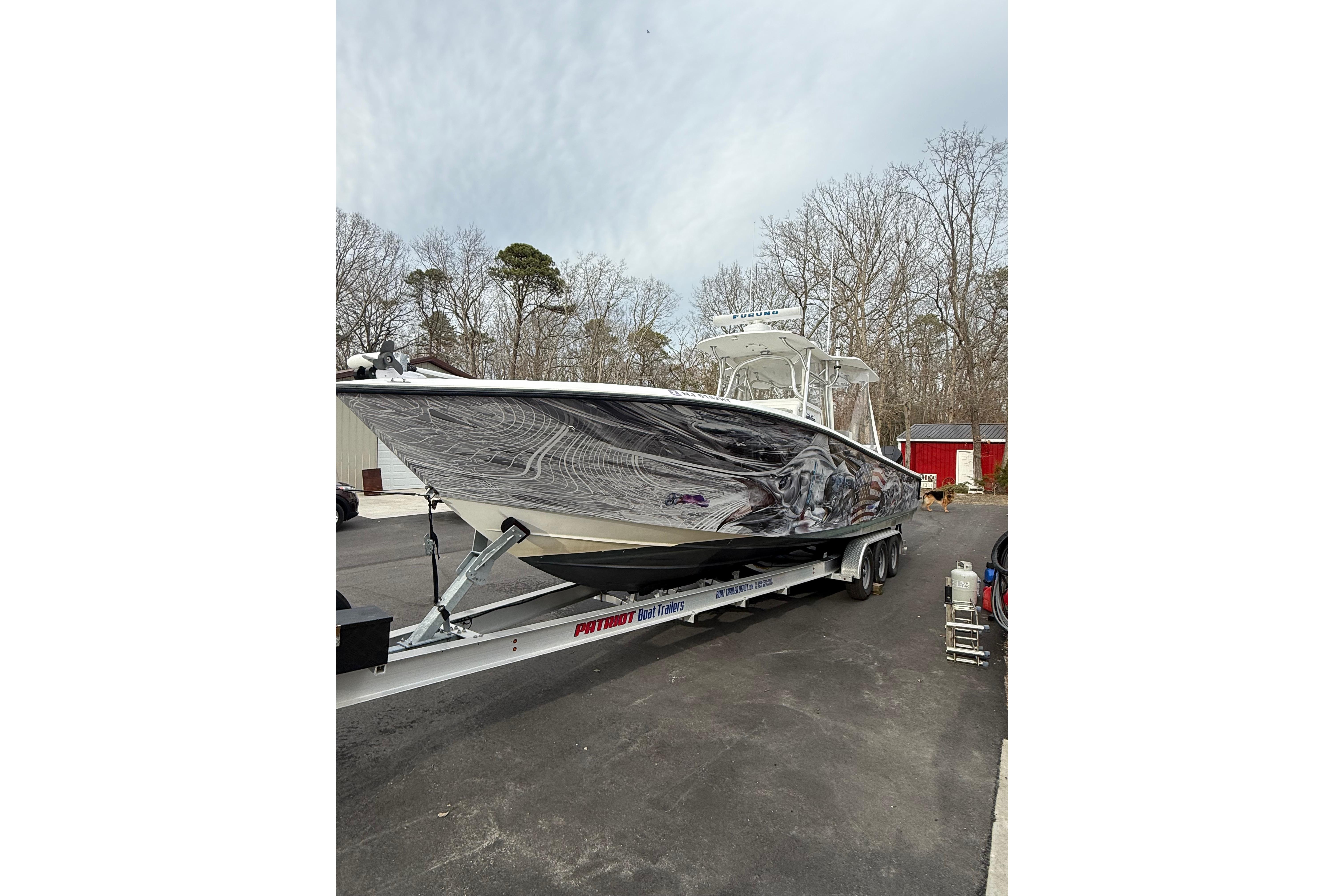 2006 SeaVee 340B boat on trailer, parked outdoors with trees in background.
