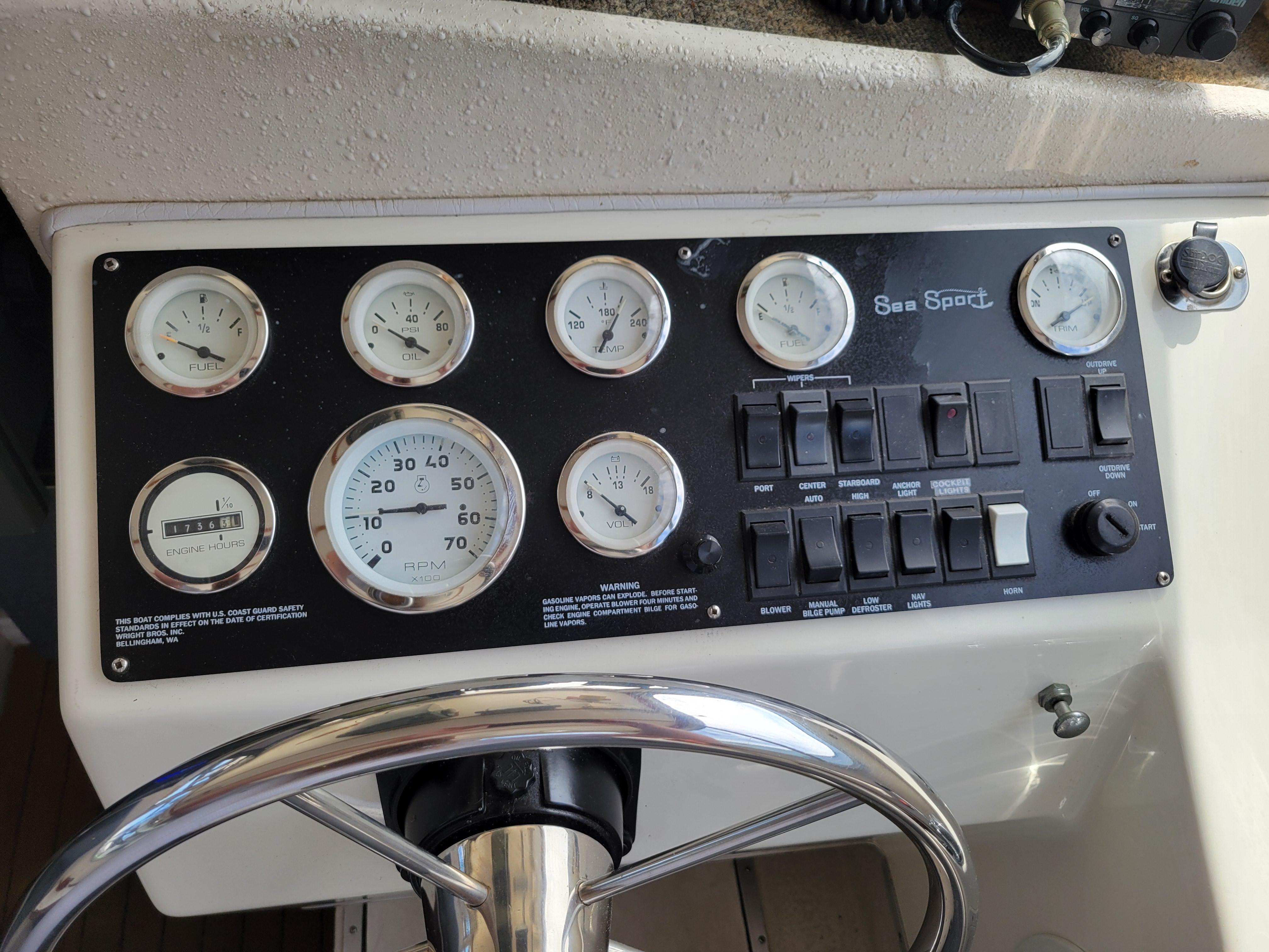 Control panel of a 1999 SeaSport 2400 XL Limited boat with gauges and switches.