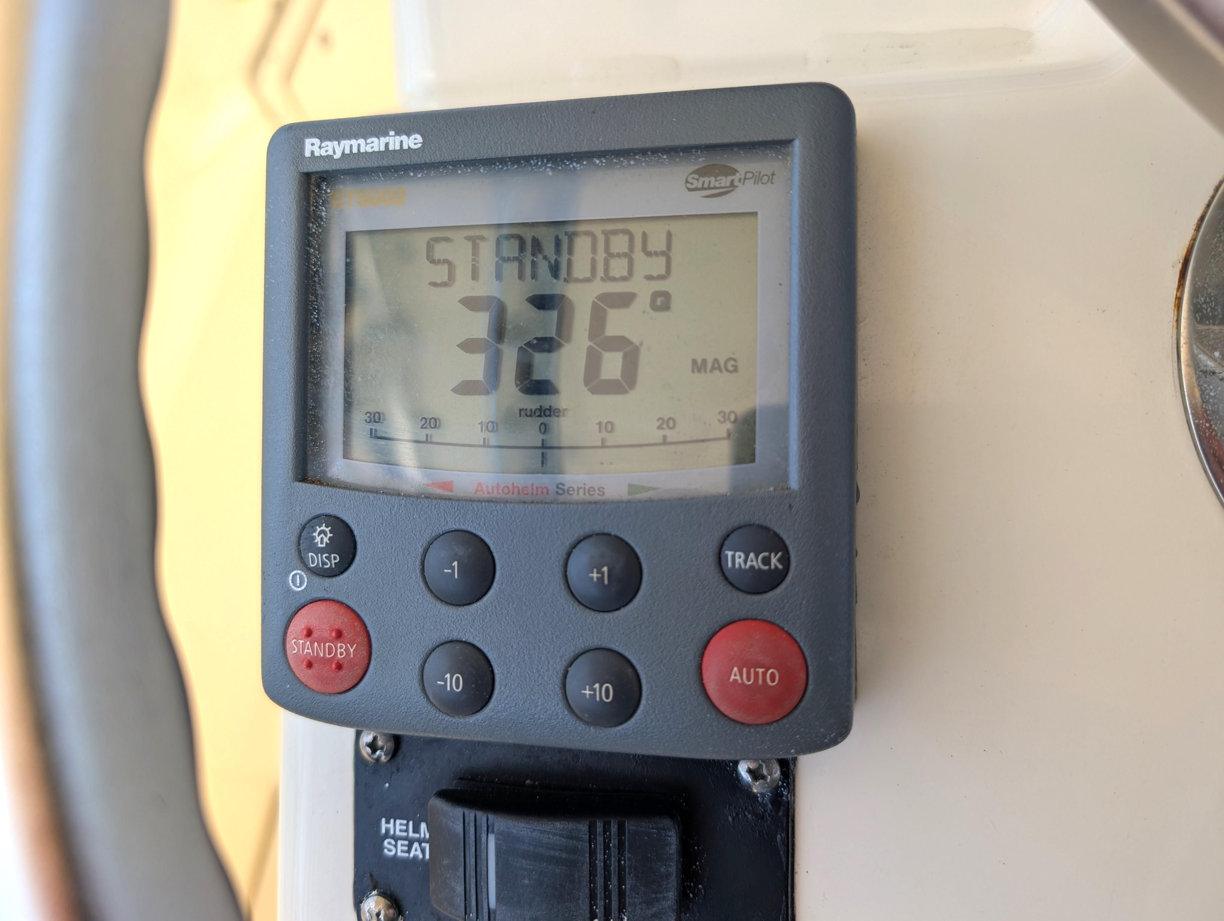Raymarine autopilot display on 2001 Pursuit 3070 Offshore Center Console showing 326 degrees.
