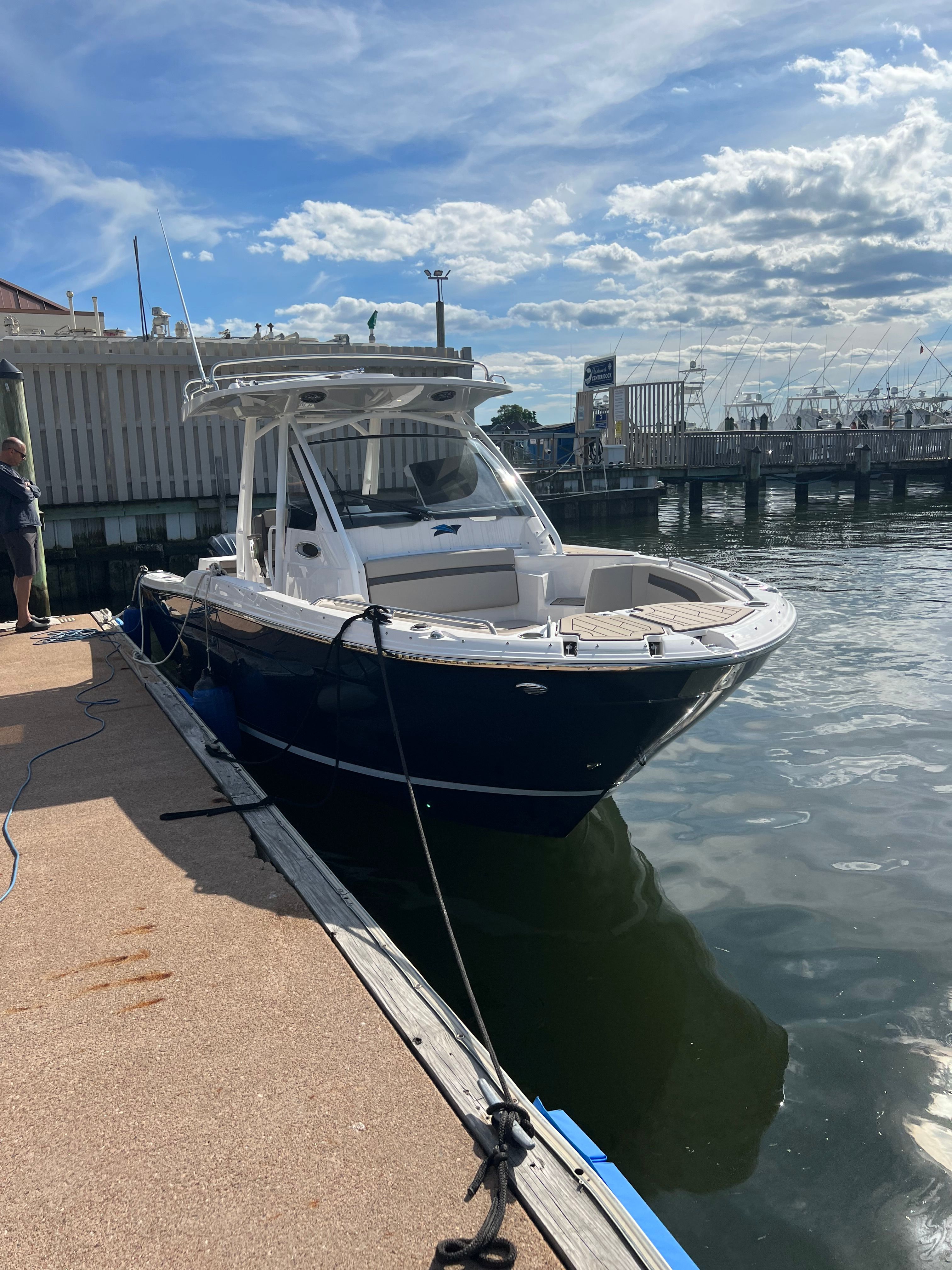 A 2022 Cutwater C-24 CW boat docked on a sunny day.