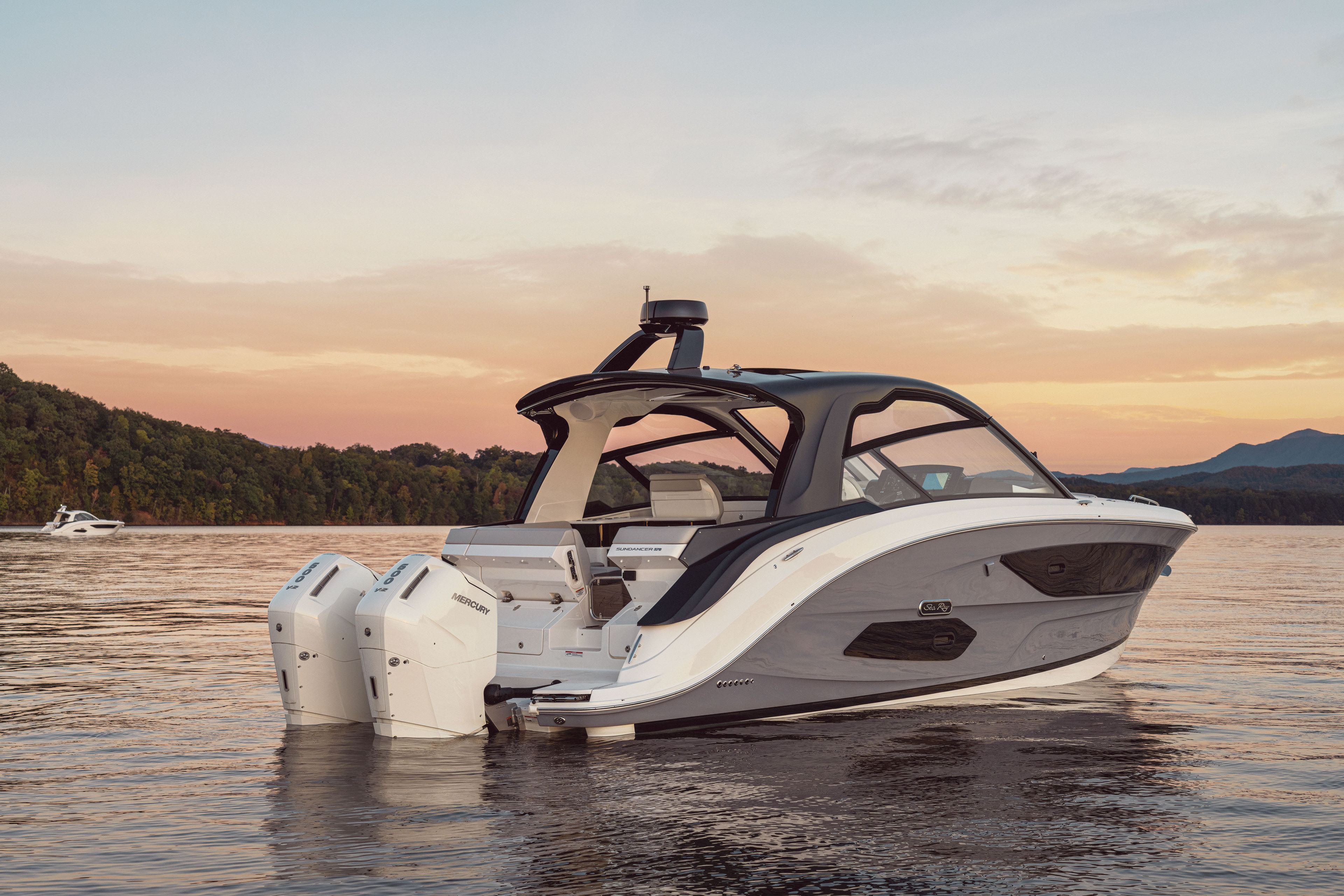 Sea Ray Sundancer 370 Outboard on calm water at sunset.