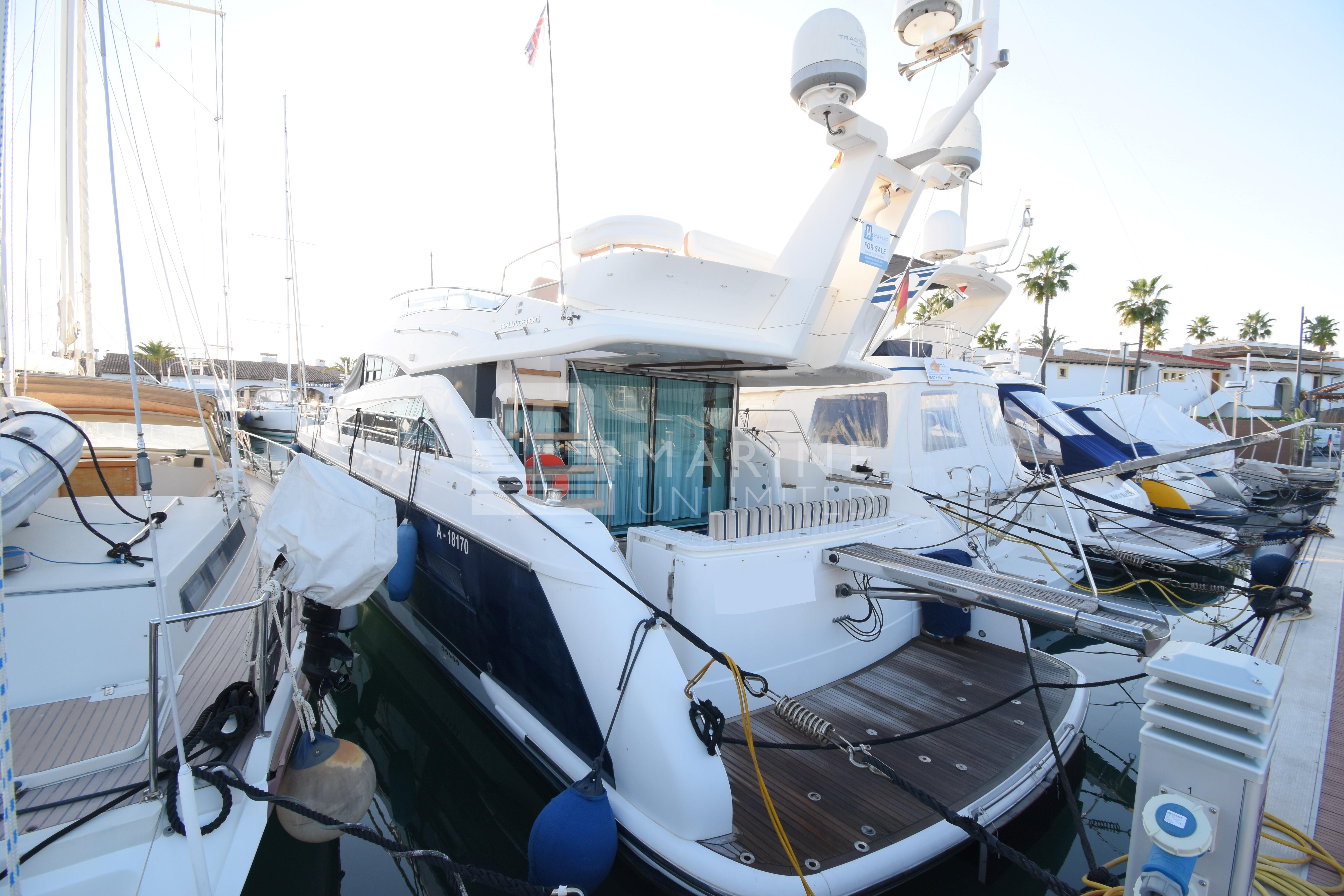 2010 Fairline Squadron 55 yacht docked at marina, surrounded by other boats.