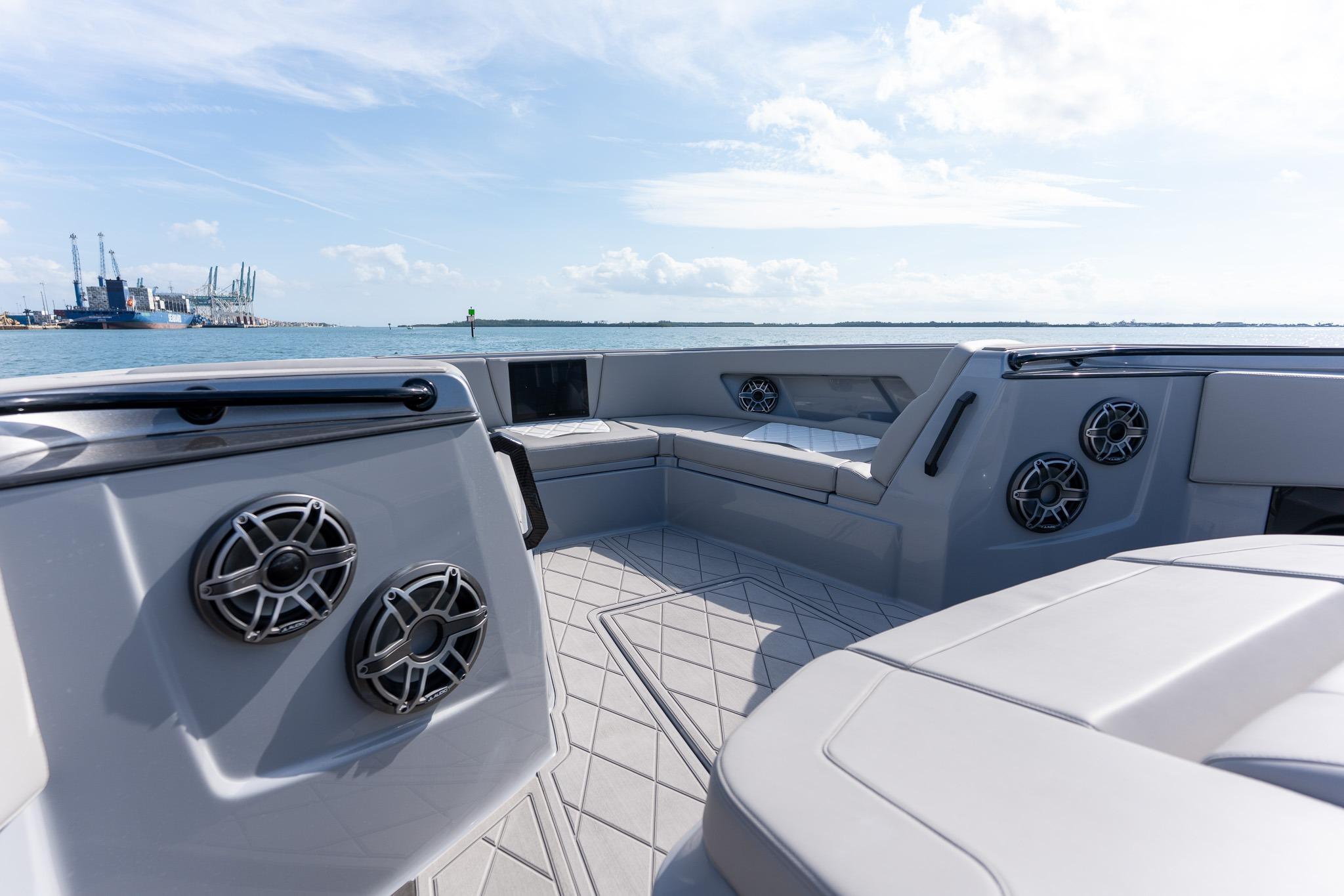 Luxurious 2026 Deep Impact 499 Sport boat interior with sleek seating and modern speakers.