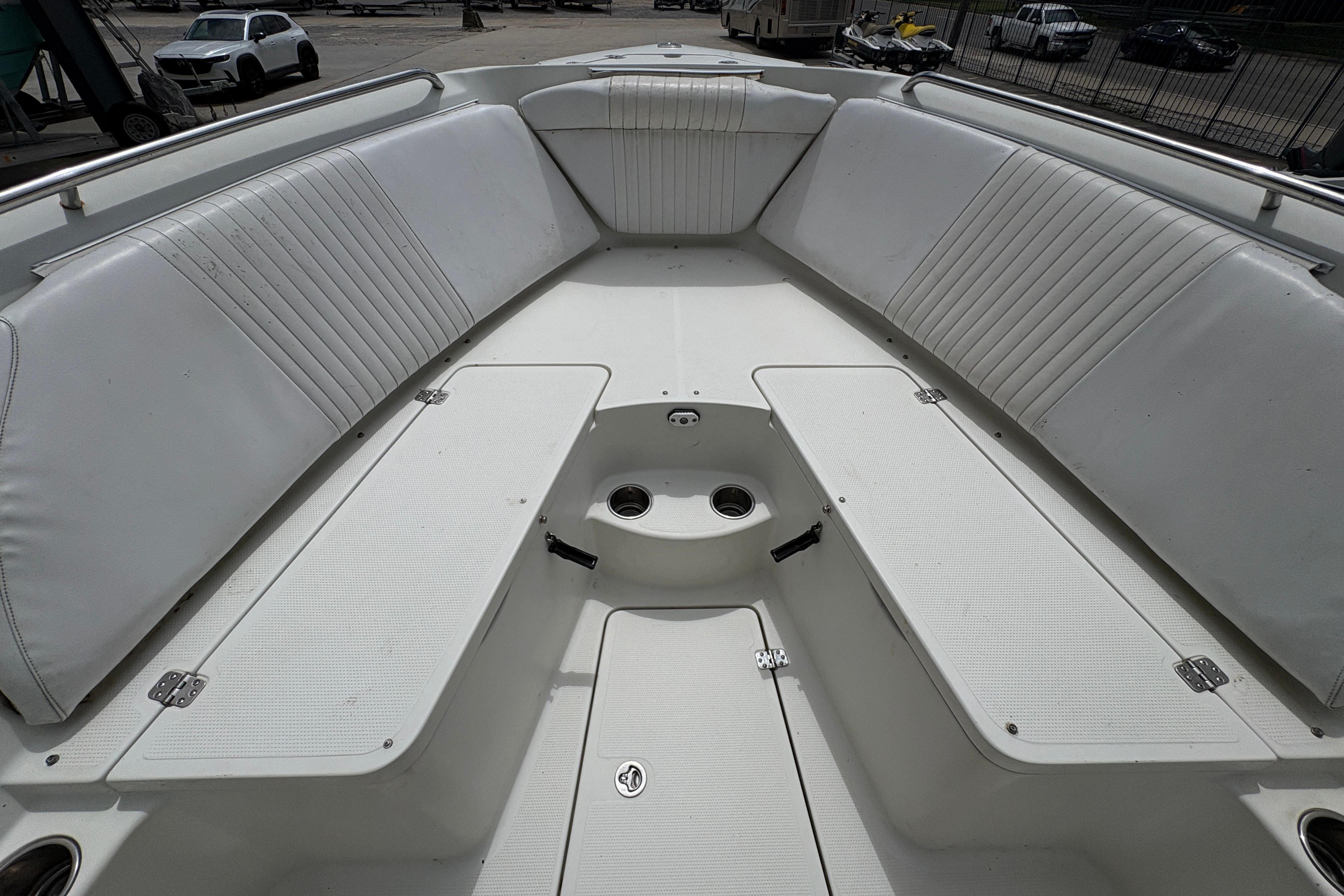 Spacious interior of 2006 Sail Faish 2360 boat with white seating and storage compartments.