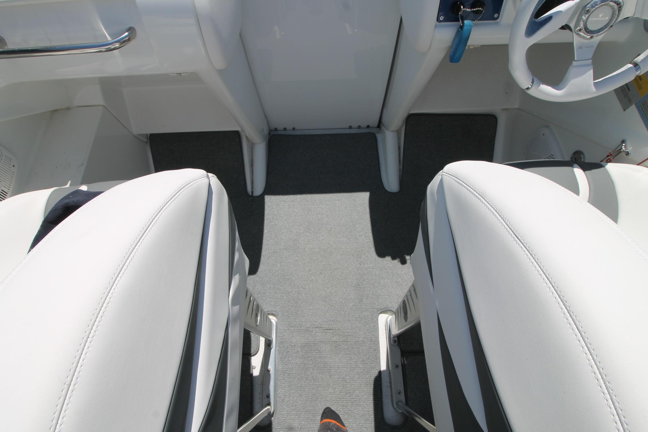 Interior of a 2006 Formula 292 FASTech boat, featuring white seating and steering wheel.