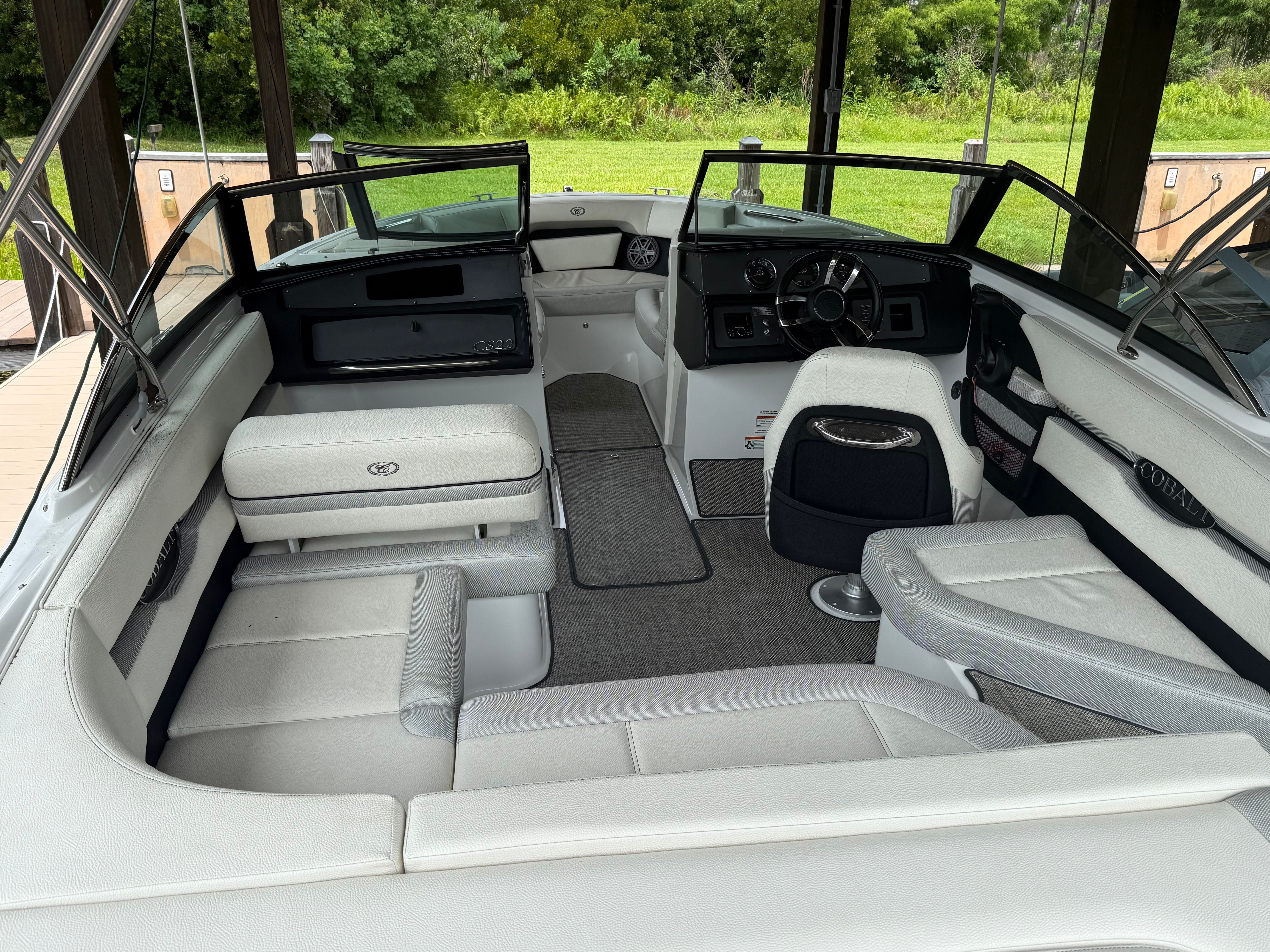 Interior view of a Cobalt CS22 Bowrider with gray upholstery and steering wheel.