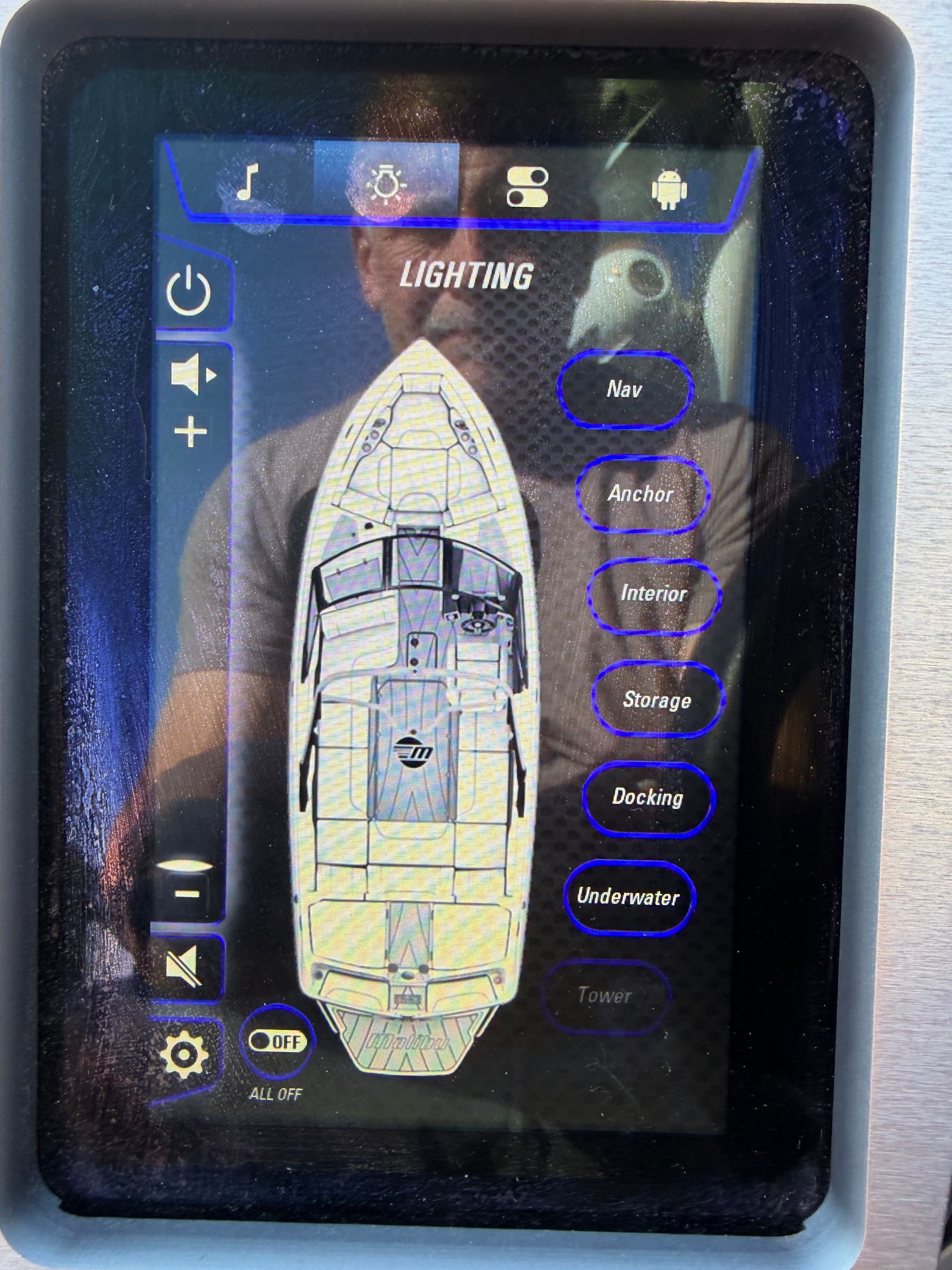 Touchscreen display on a boat with lighting control and various navigation options.