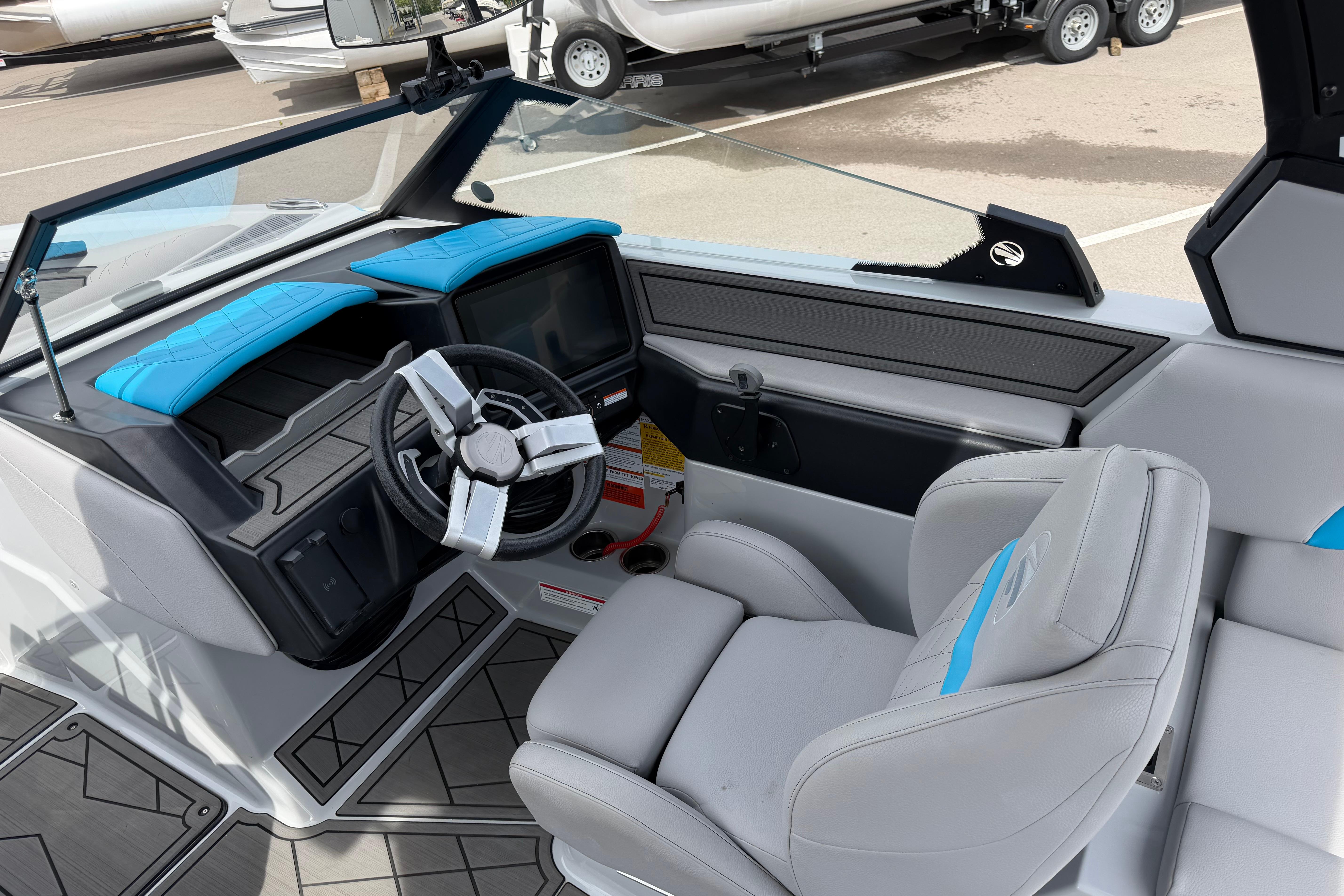 2024 Tigé Z1 boat interior with modern steering and blue-accented seating.