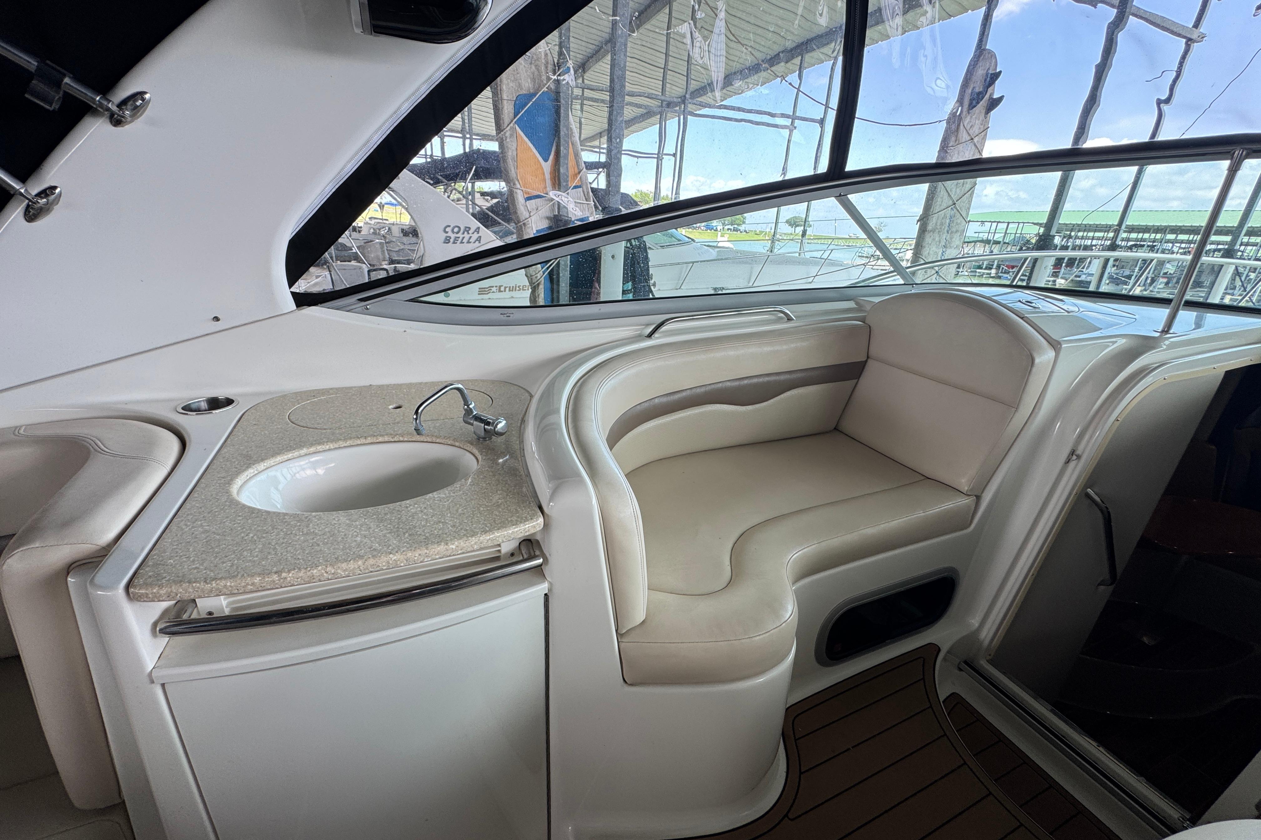 Interior of 2006 Chaparral 330 Signature yacht with seating and sink area.