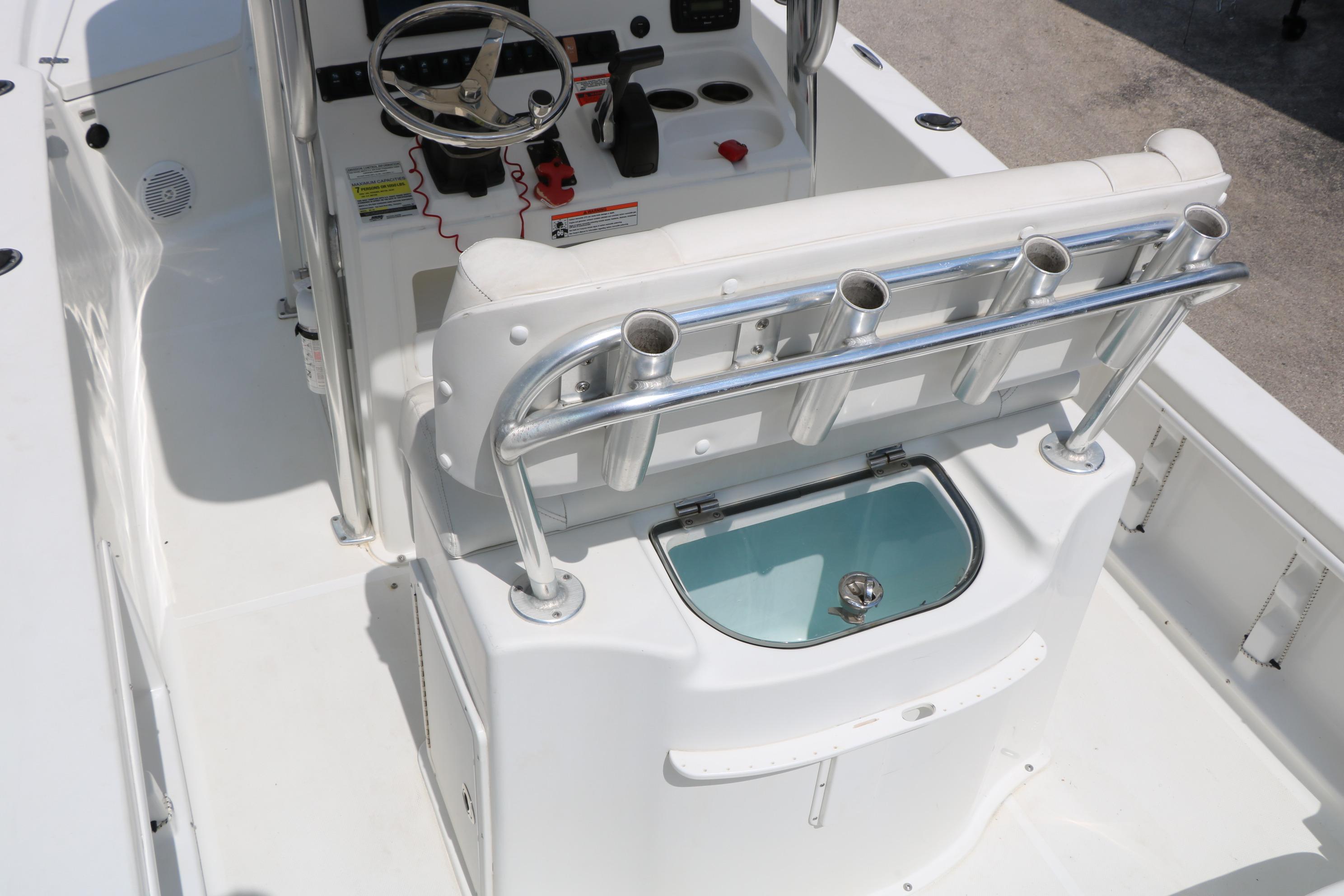 2015 Sea Hunt BX 22 BR boat interior with steering console and rod holders.