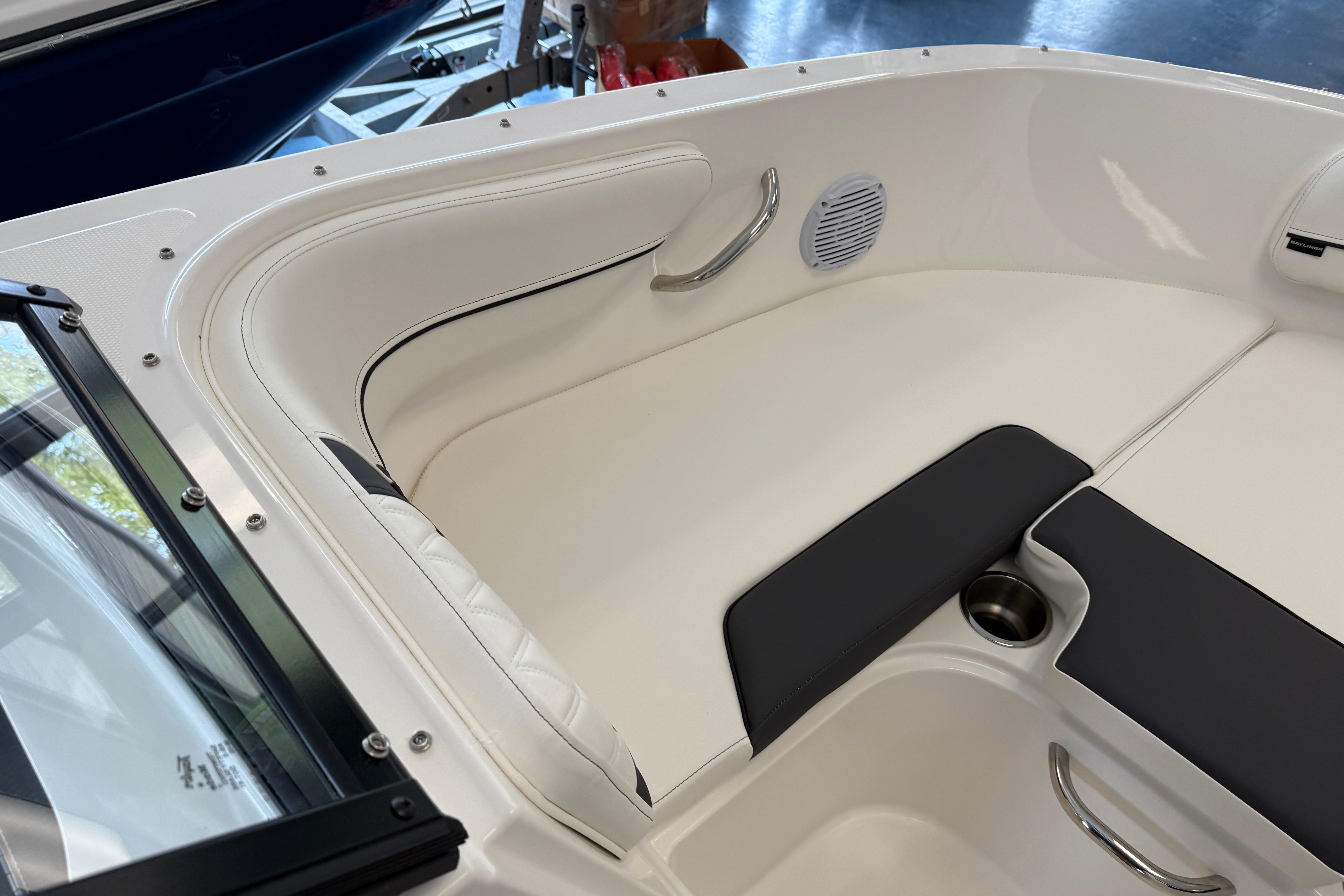 2025 Bayliner VR4 Bowrider OB interior with white seating and stainless steel accents.