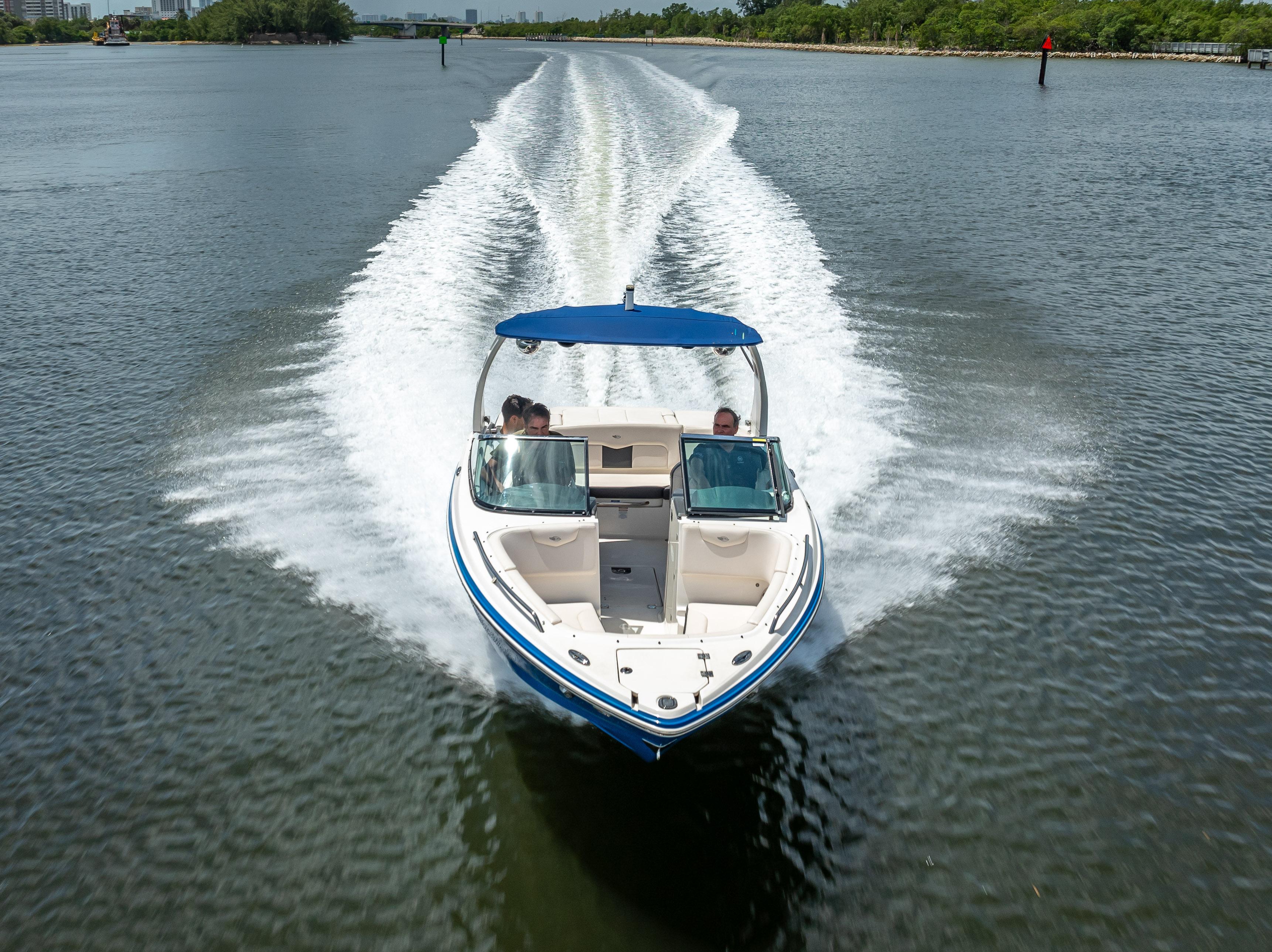 2017 Chaparral 227 SSX boat cruising on a calm waterway.