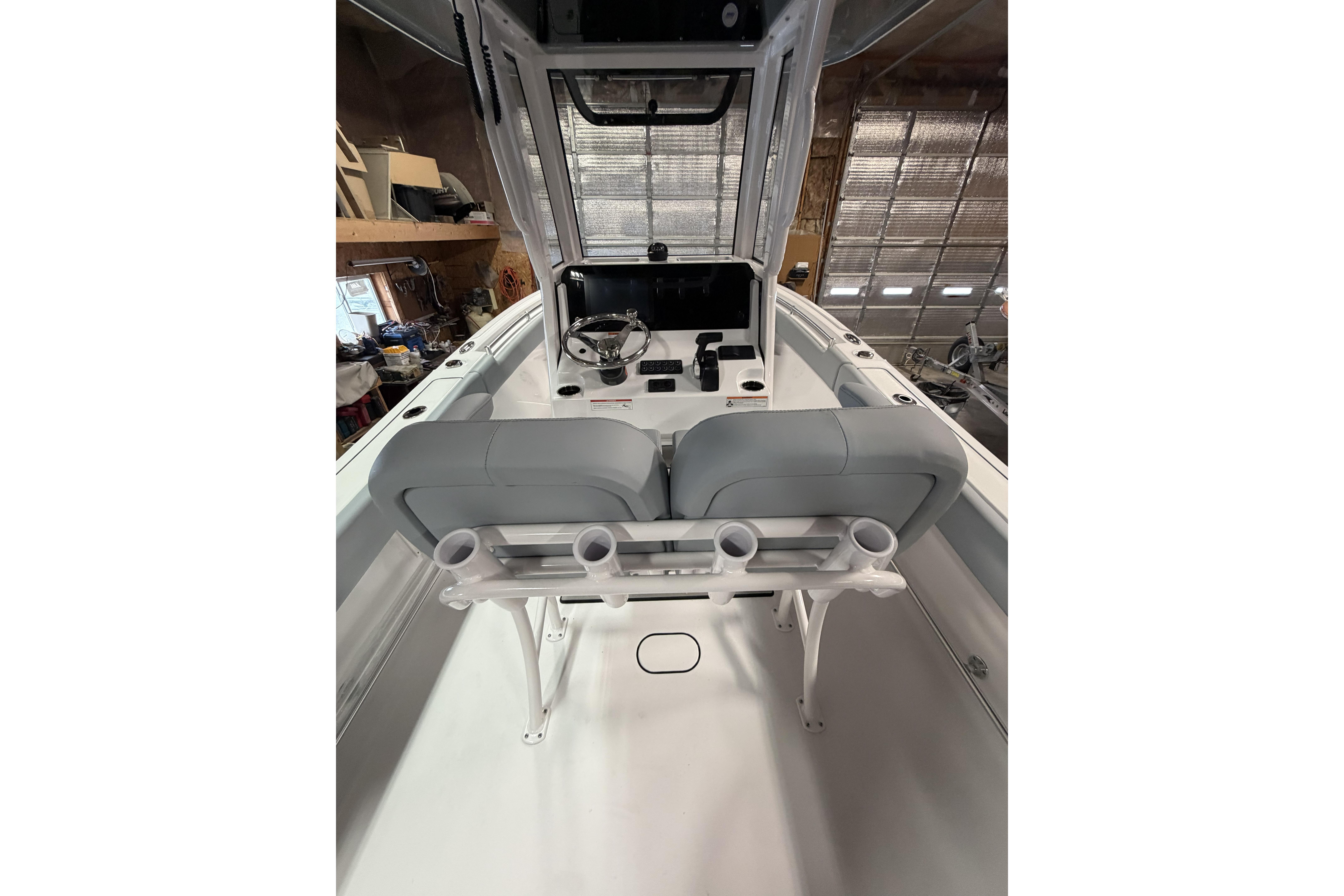 2026 Sportsman Open 232 Center Console boat interior with helm and seating.