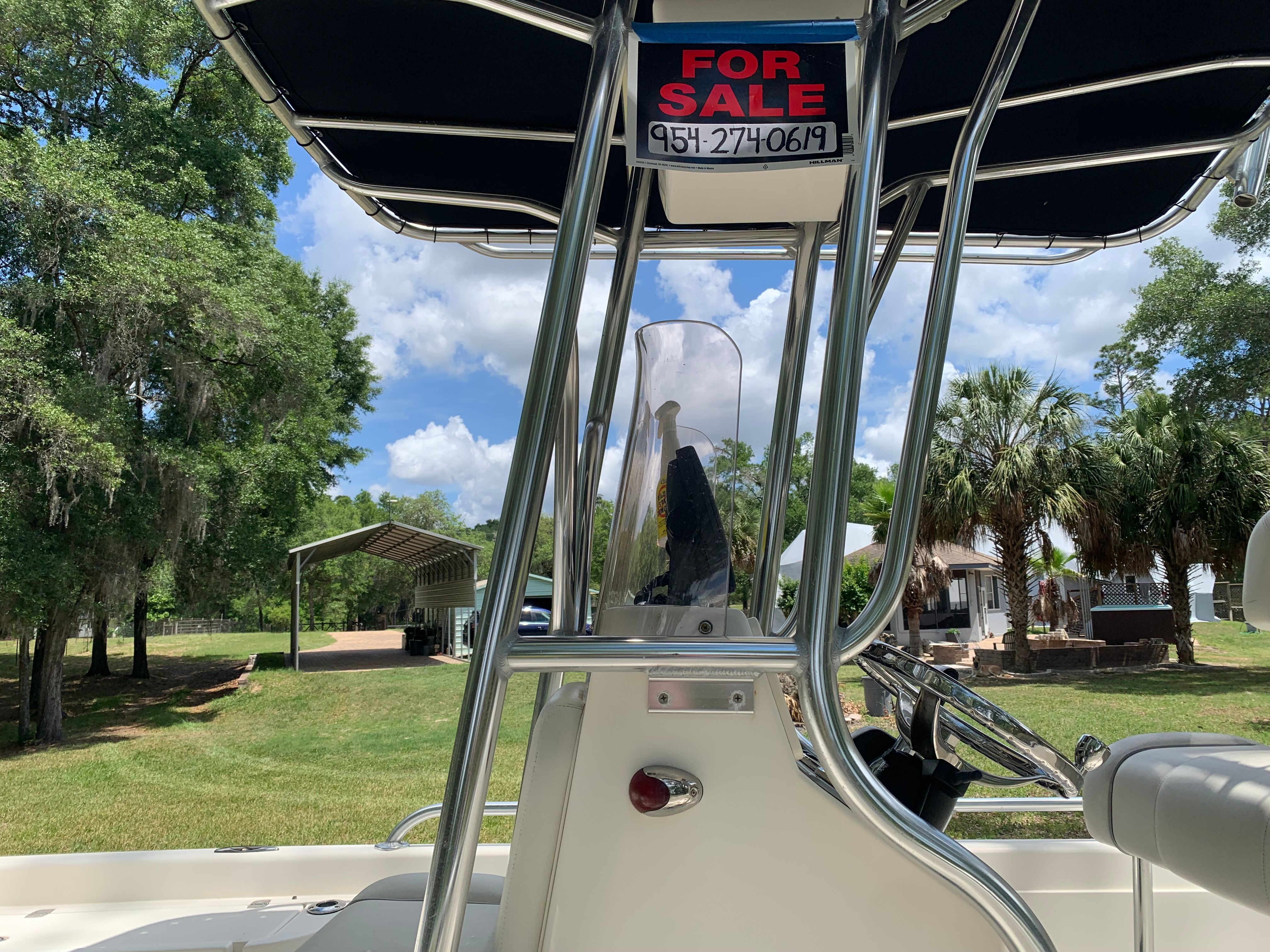 2007 ShearWater 23 LTZ boat for sale, sunny day, green surroundings.