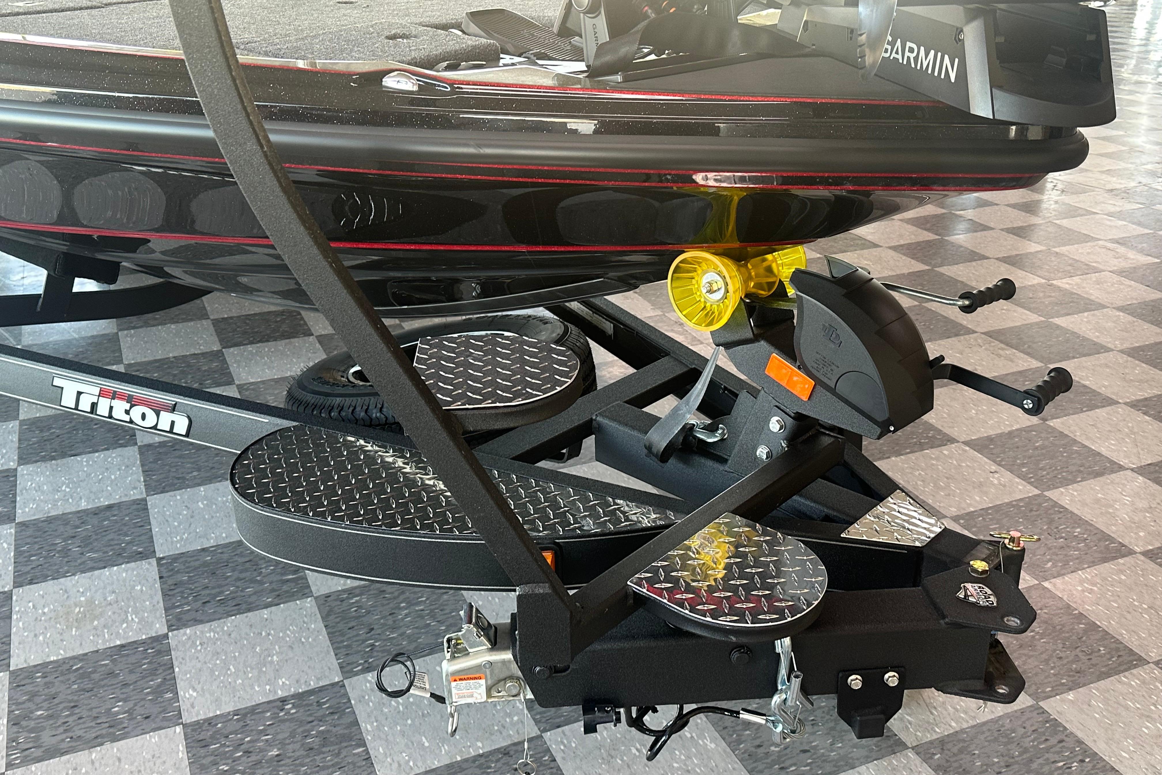 2026 Triton 20XP Patriot boat on a trailer with checkered flooring background.