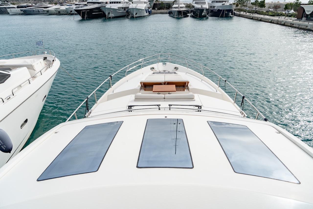 2012 Princess V72 yacht docked in marina, surrounded by other luxury boats.