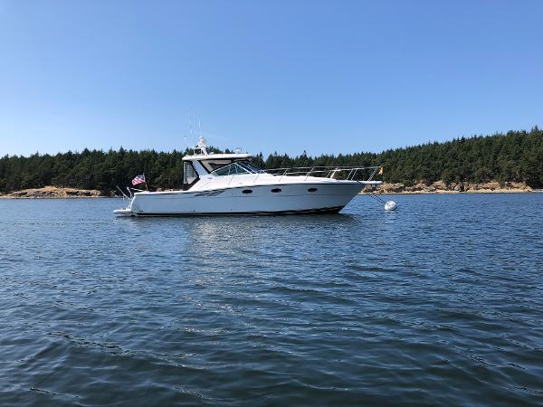 2003 Tiara Yachts 3500 Open on calm water with forested shoreline in background.
