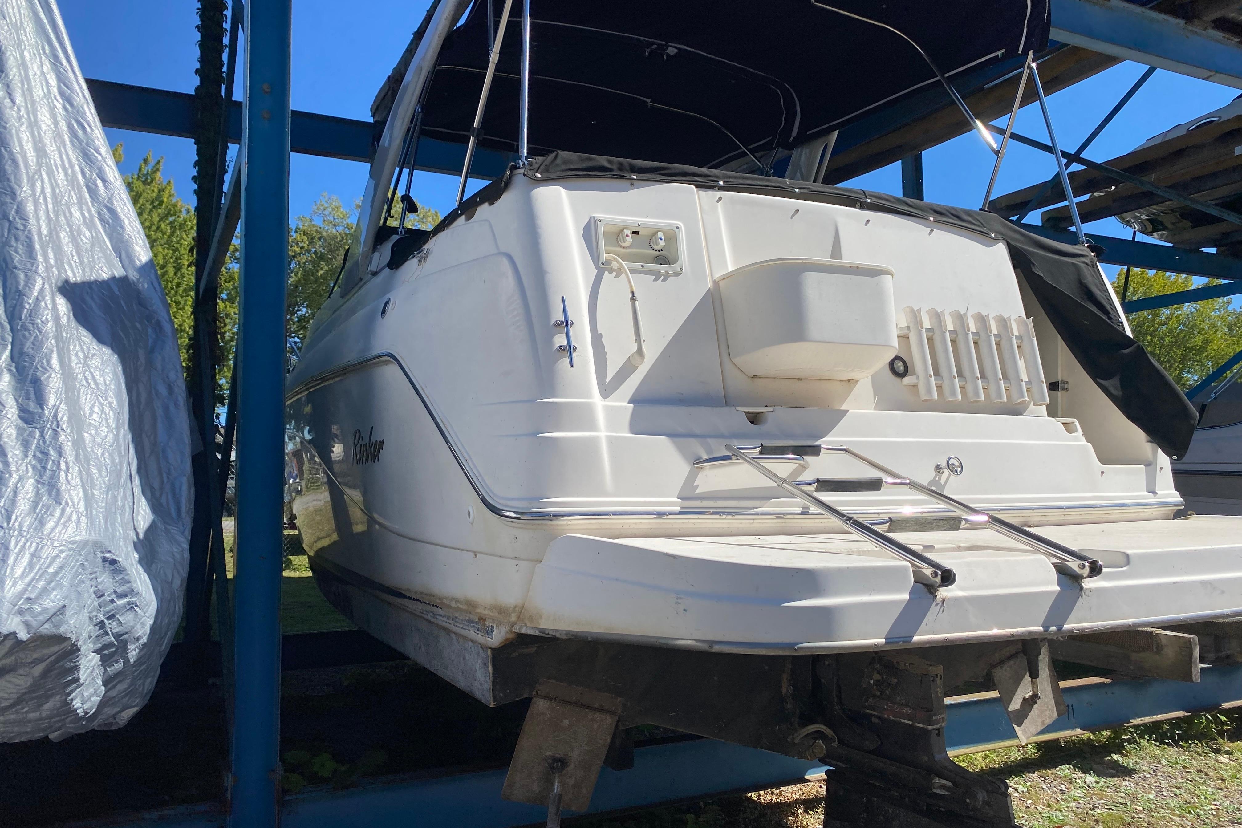 2003 Rinker Fiesta Vee 270 boat on a storage rack, rear view.