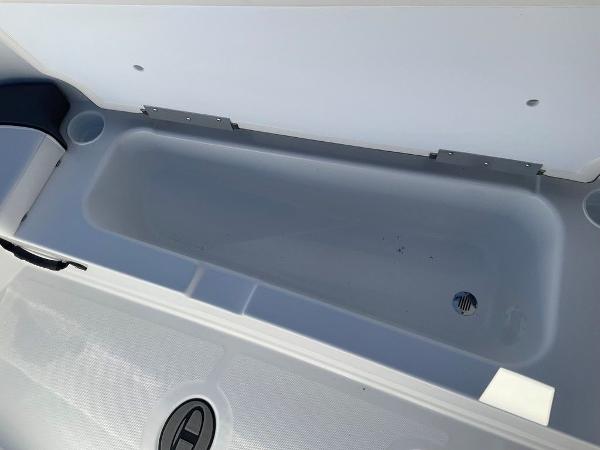 2025 Tahoe T18 boat storage compartment with drain plug.