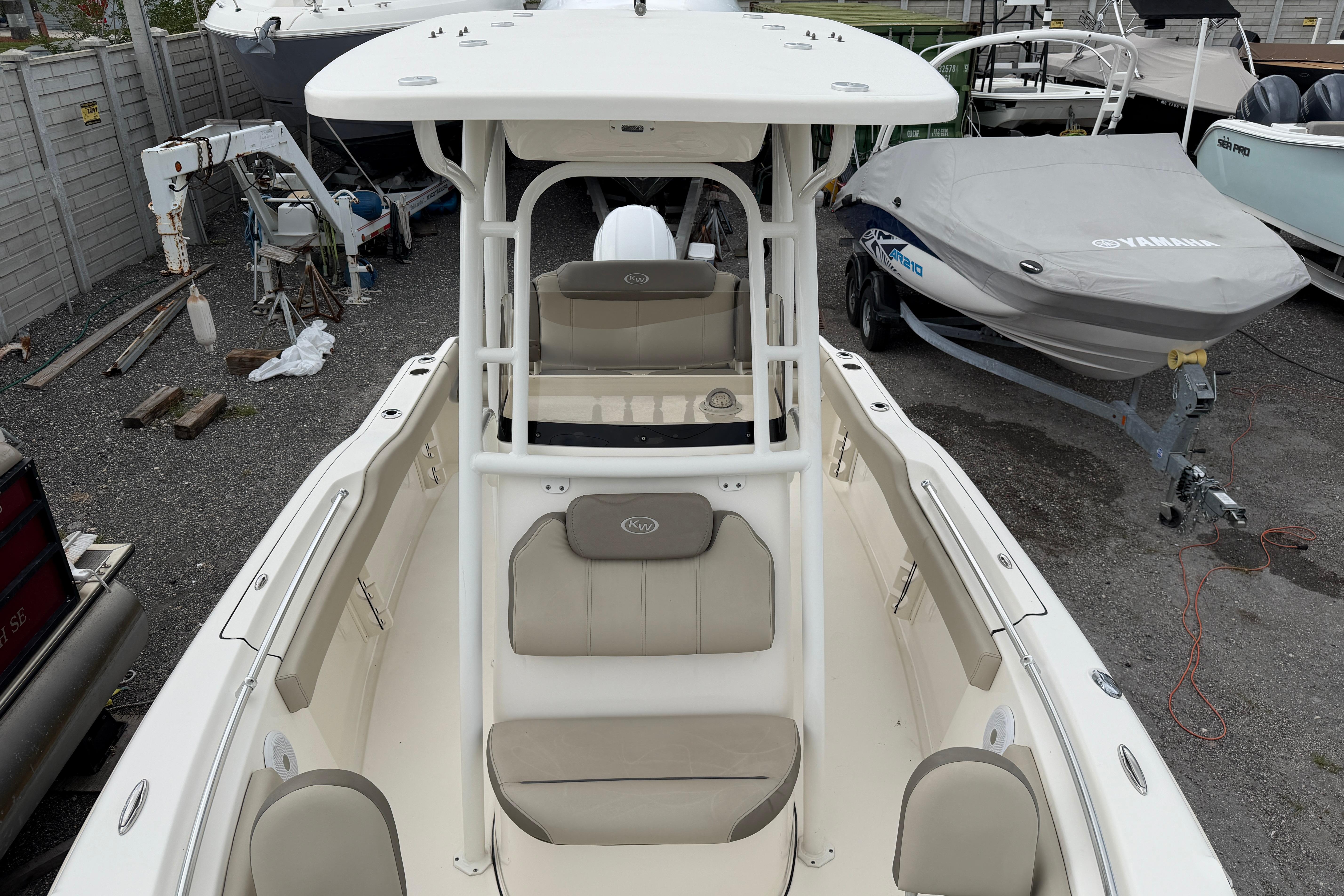 2022 Key West 219 FS boat with beige seating, parked in a marina.